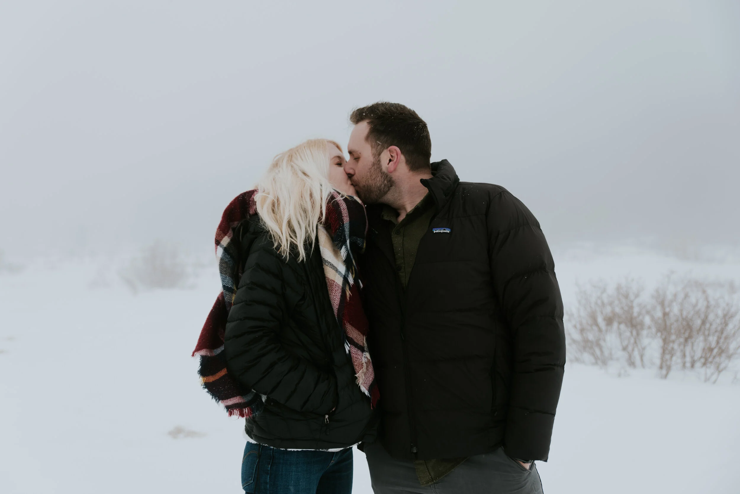 couple-kisses-in-engagement-session