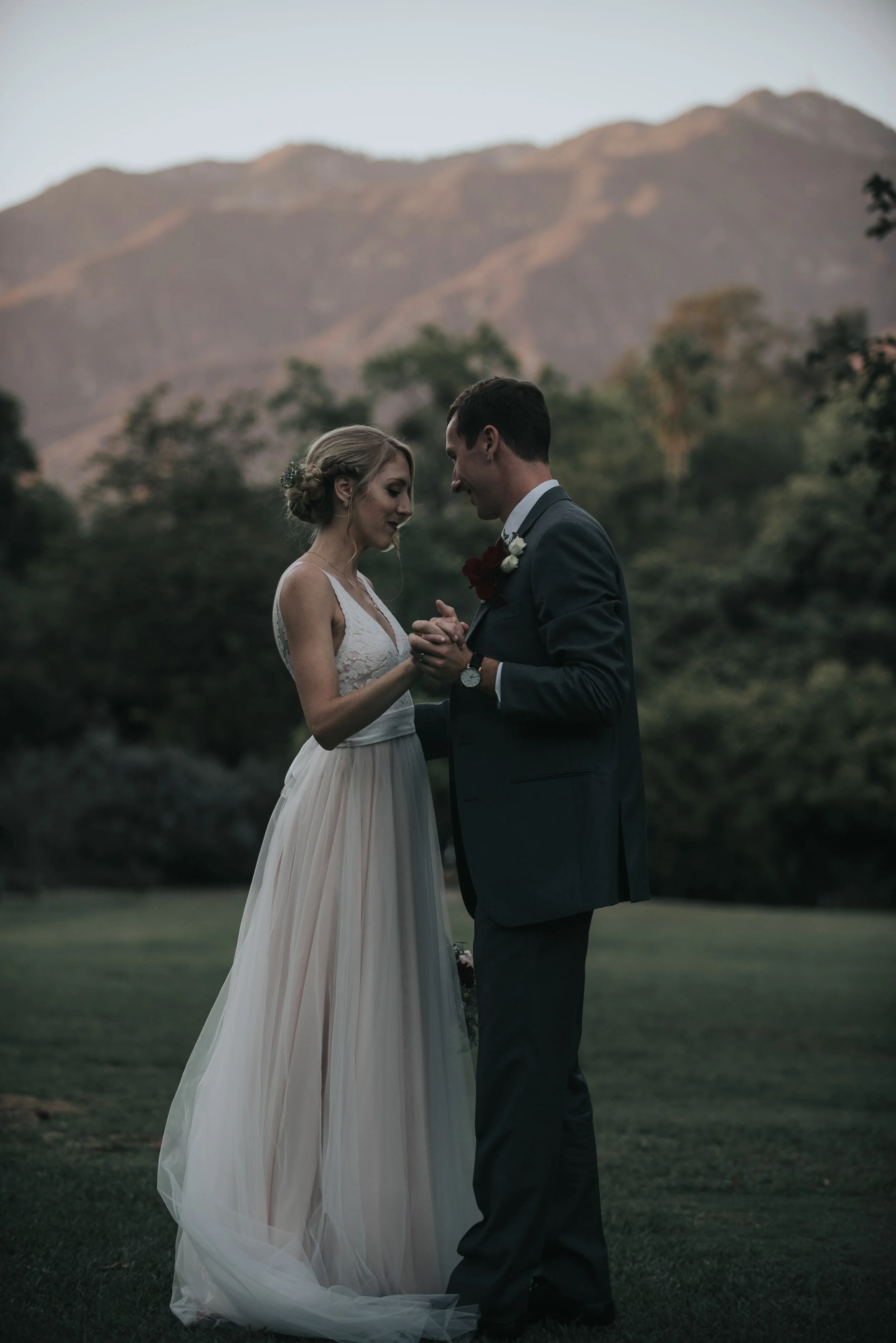 A bride and groom dances next to the mountains after planning a destination elopement or wedding