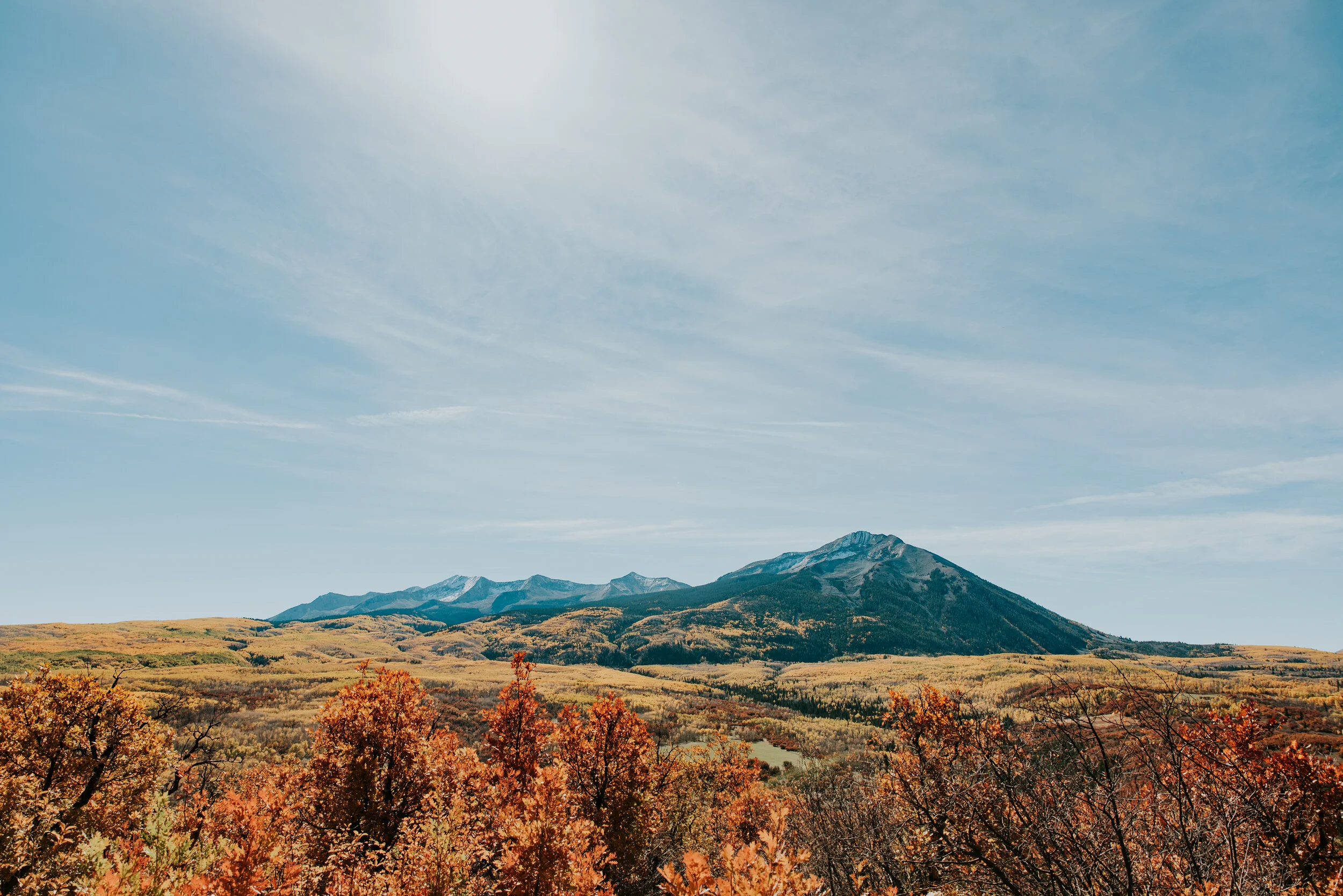 A lone mountain in a field of fall foliage near Crested Butte as a destination wedding location idea