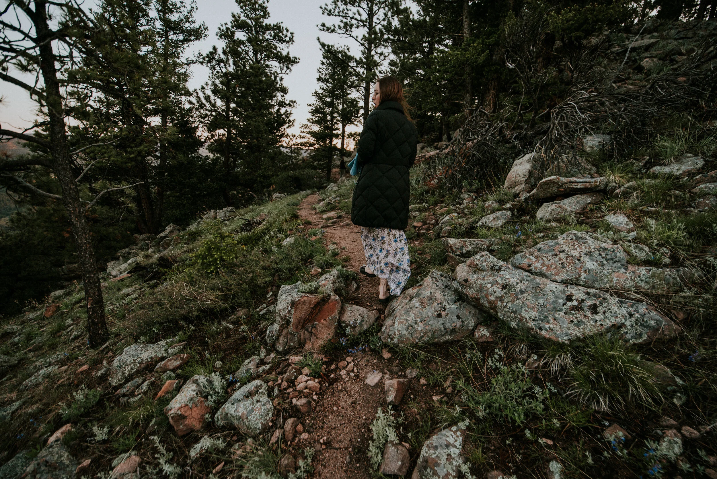 A bride hikes up a mountain during an elopement after deciding how many hours of photography she needed with Kat WIckstrom Photography