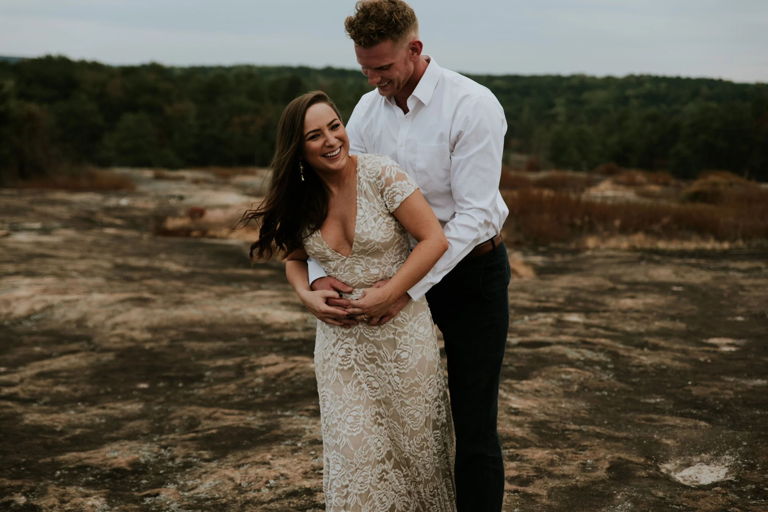 A couple embraces on Arabia Mountain in Atlanta Georgia after deciding how many hours of photography they needed for an elopement