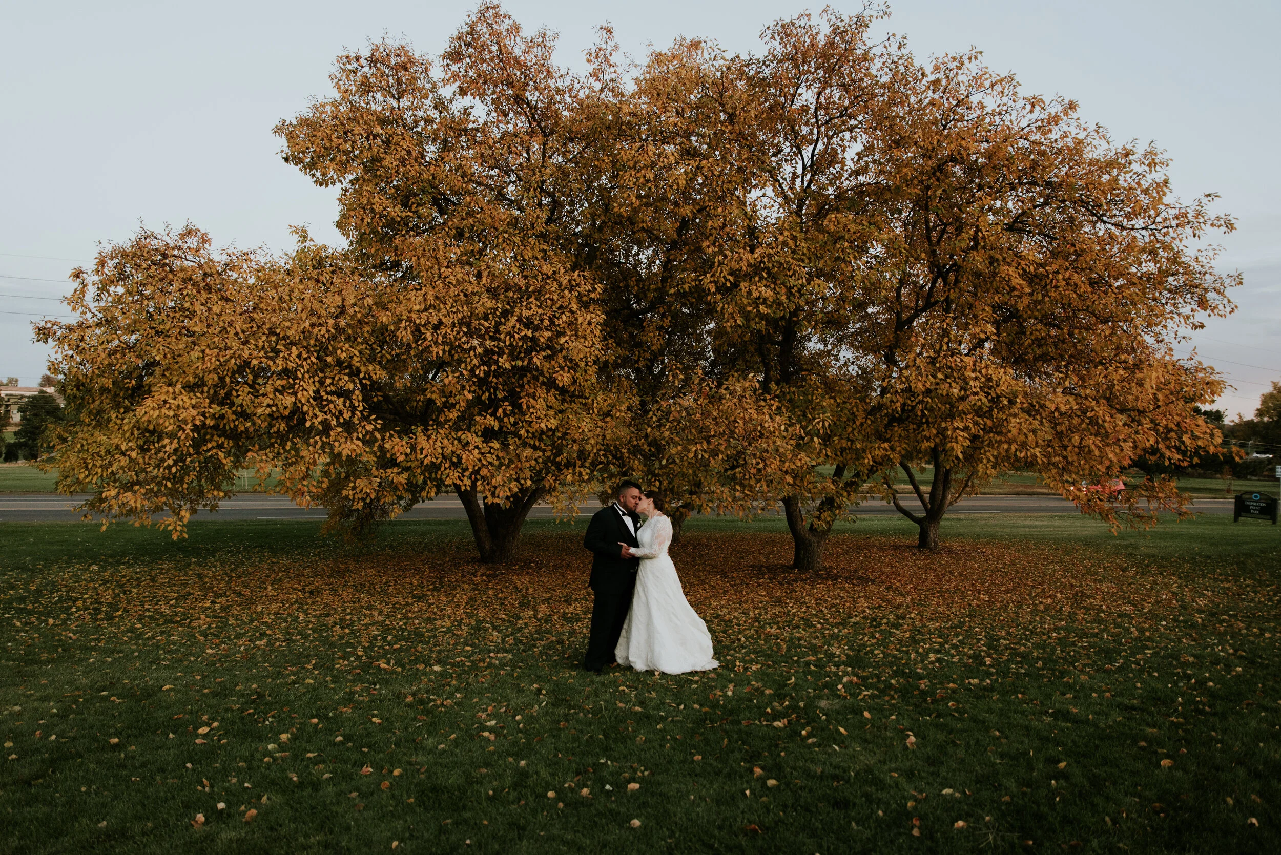 Bride and groom kiss in fall wedding during the ideal wedding timeline