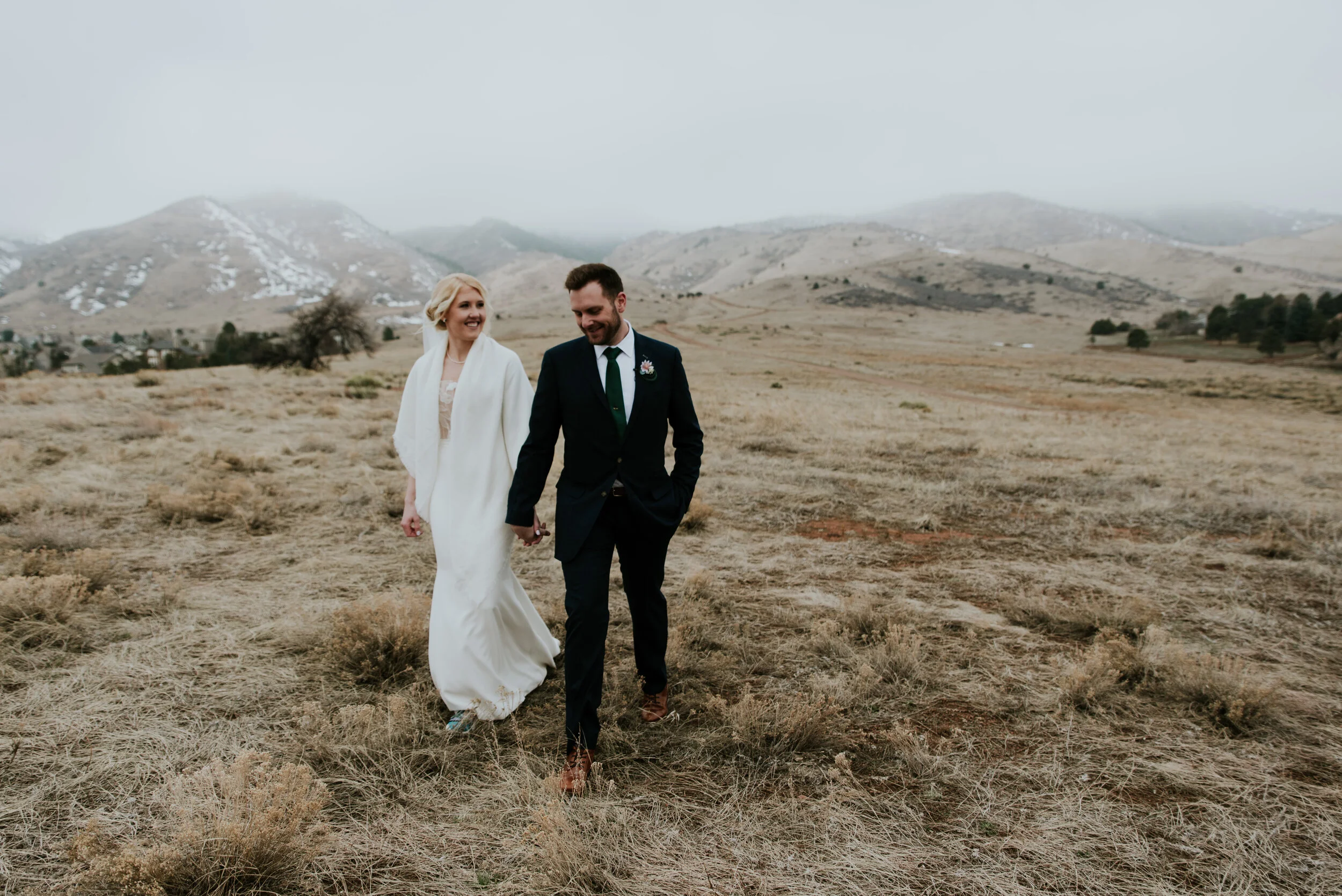 couple-walking-manor-house-field
