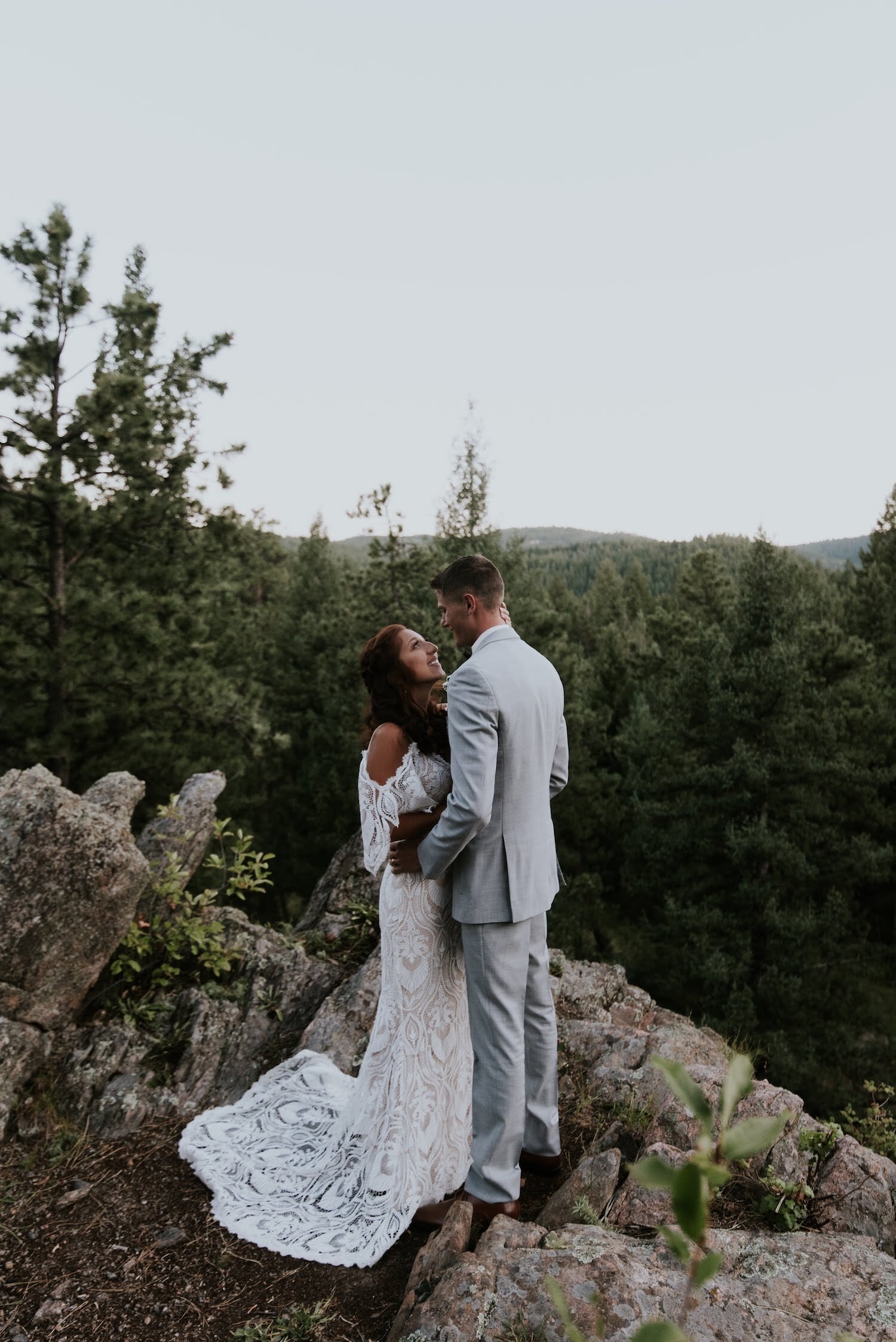A couple embraces on the side of a mountain in Colorado with Kat Wickstrom Photography, a destination wedding and adventure elopement photographer