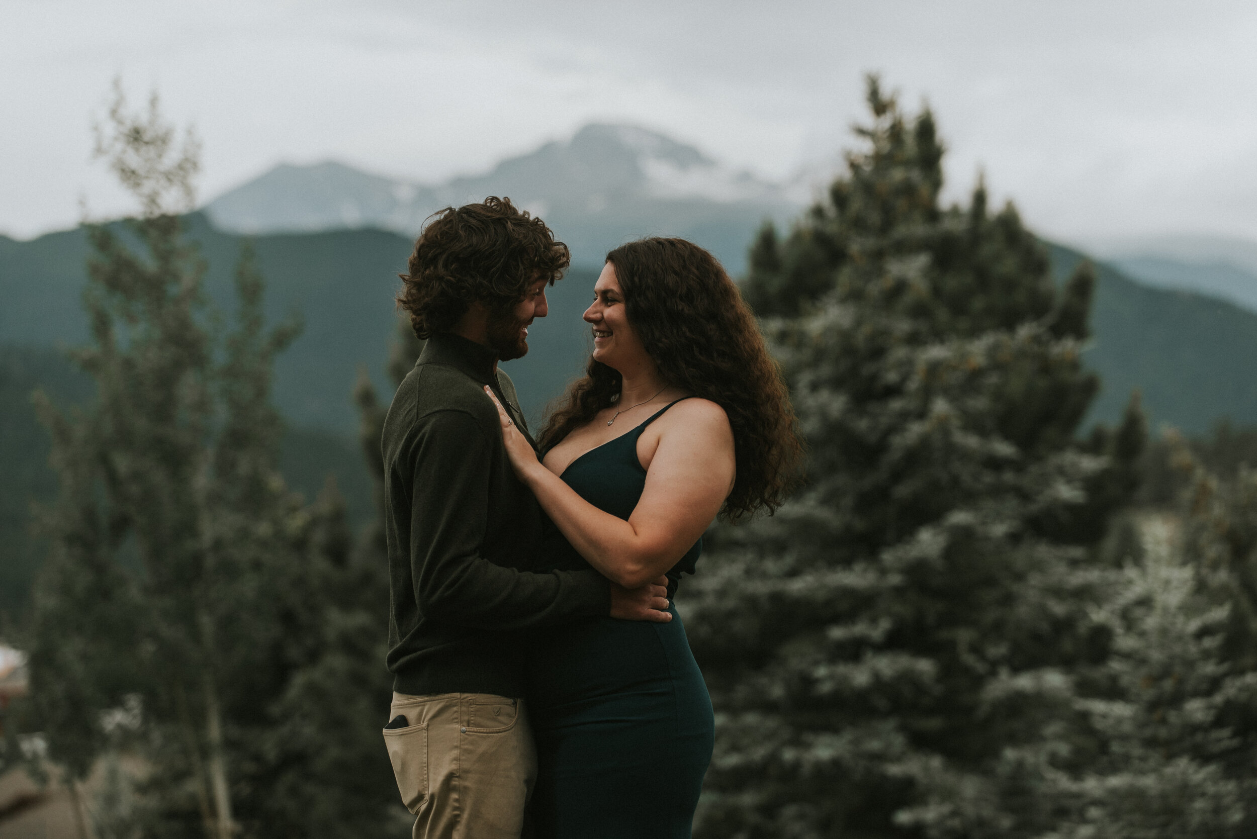 couple_holds_each_other_in_mountain_engagement_photo