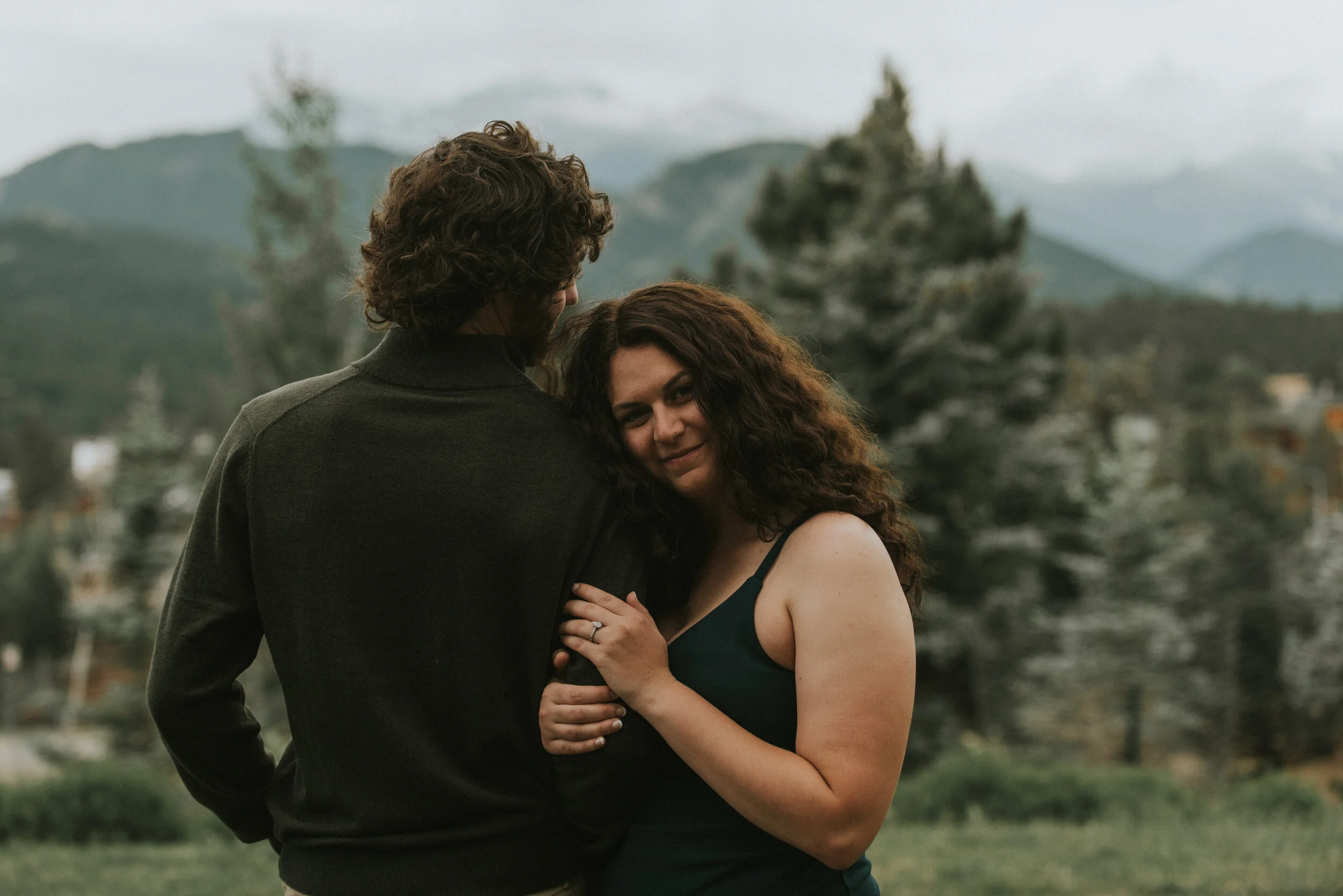 bride_smiles_during_engagement_photo_session_in_the_mountains