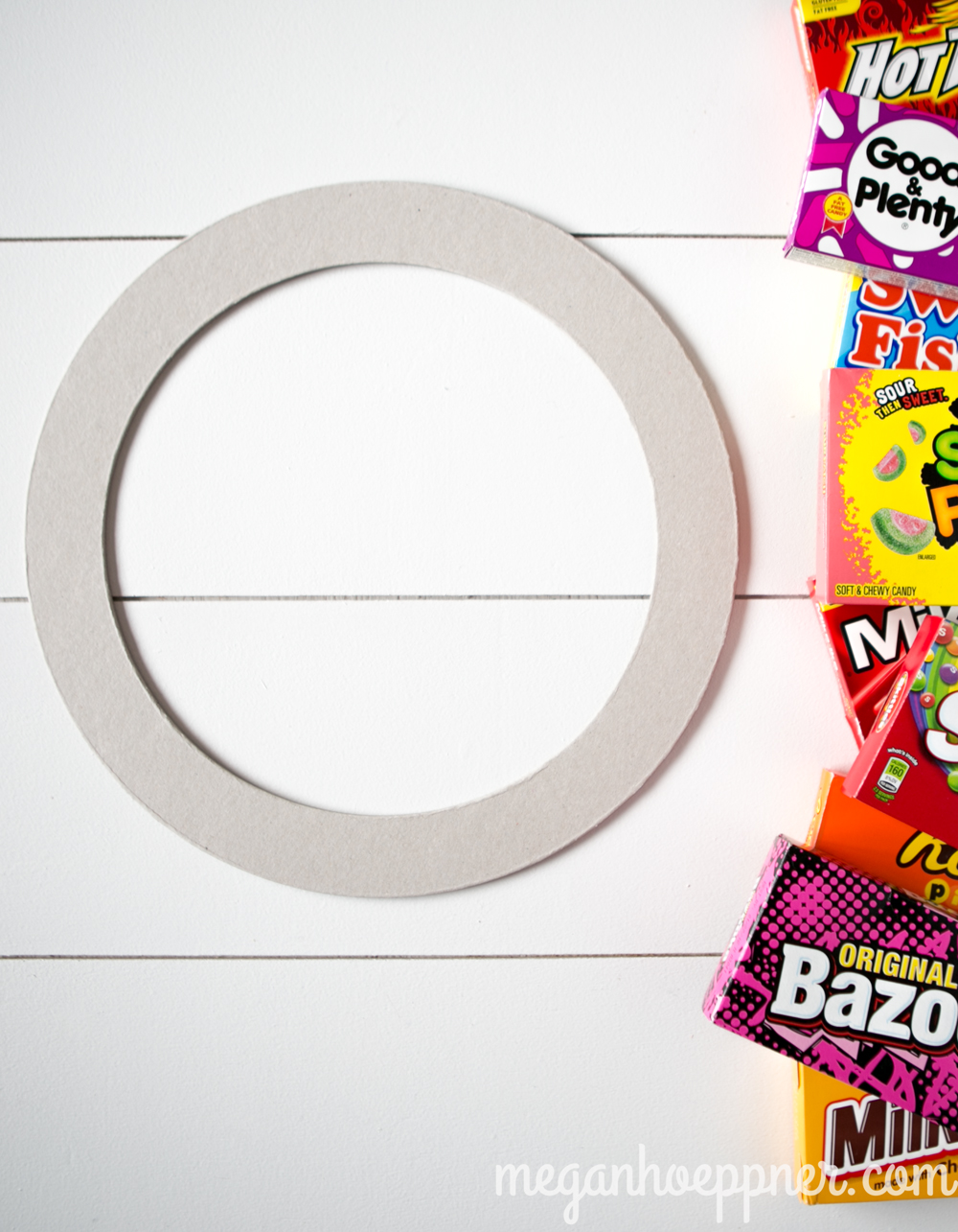 Supplies Needed: Wreath base (I picked this chipboard one up at Paper Source); Empty candy boxes (The Dollar Store is a great spot for these!)
