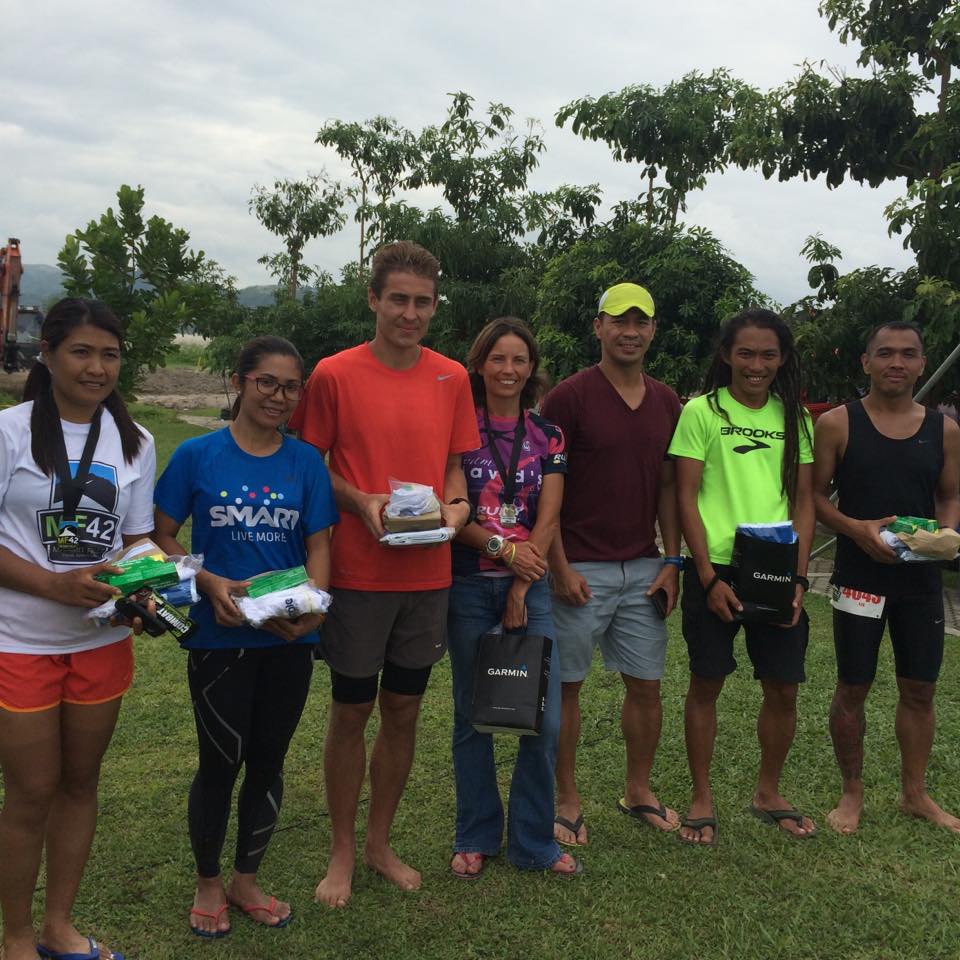 Joanna Plumbley in the middle with CM50 & MF 42 race director Jon Lacanlale on her left. 
