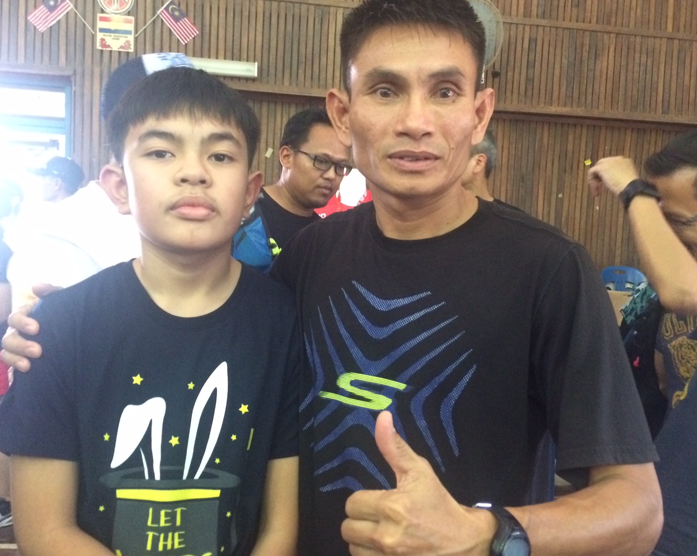 Sefli Ahar scored his first trail race victory outside of his native Brunei. Here with his son. 
