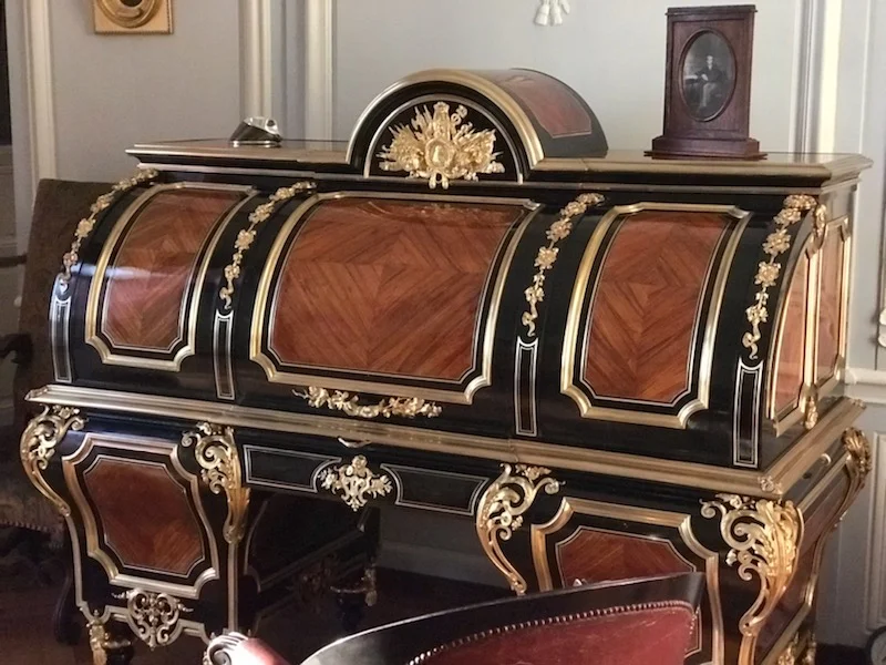 Cylinder Desk in the Duke of Aumale’s Bedroom - Oak with pear wood, rosewood veneer, ebony and brass. Gilded bronze. Designed by Brothers Jean-Michel and Guillaume Grohé, this type of desk is referred to as ‘minister desk’ and was offered to Duke of Aumale by his father, King Louis-Philippe in 1847. © Grand Palais Domaine de Chantilly
