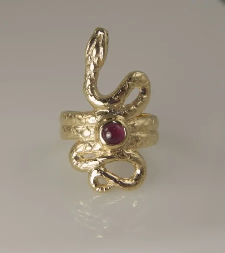 14 karat yellow gold serpent ring contains one 4mm cabochon ruby. This piece contains 100% recycled gold. Wright Macy Designs Original. 