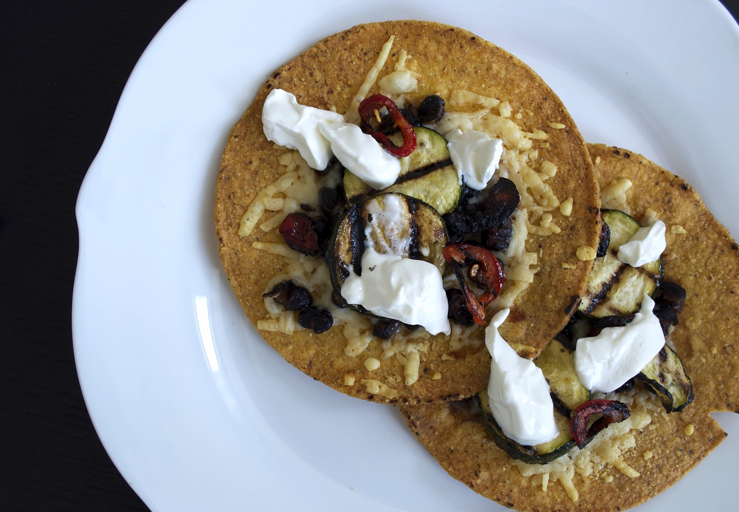 slow-cooked black bean tostadas with grilled zucchini and hot peppers