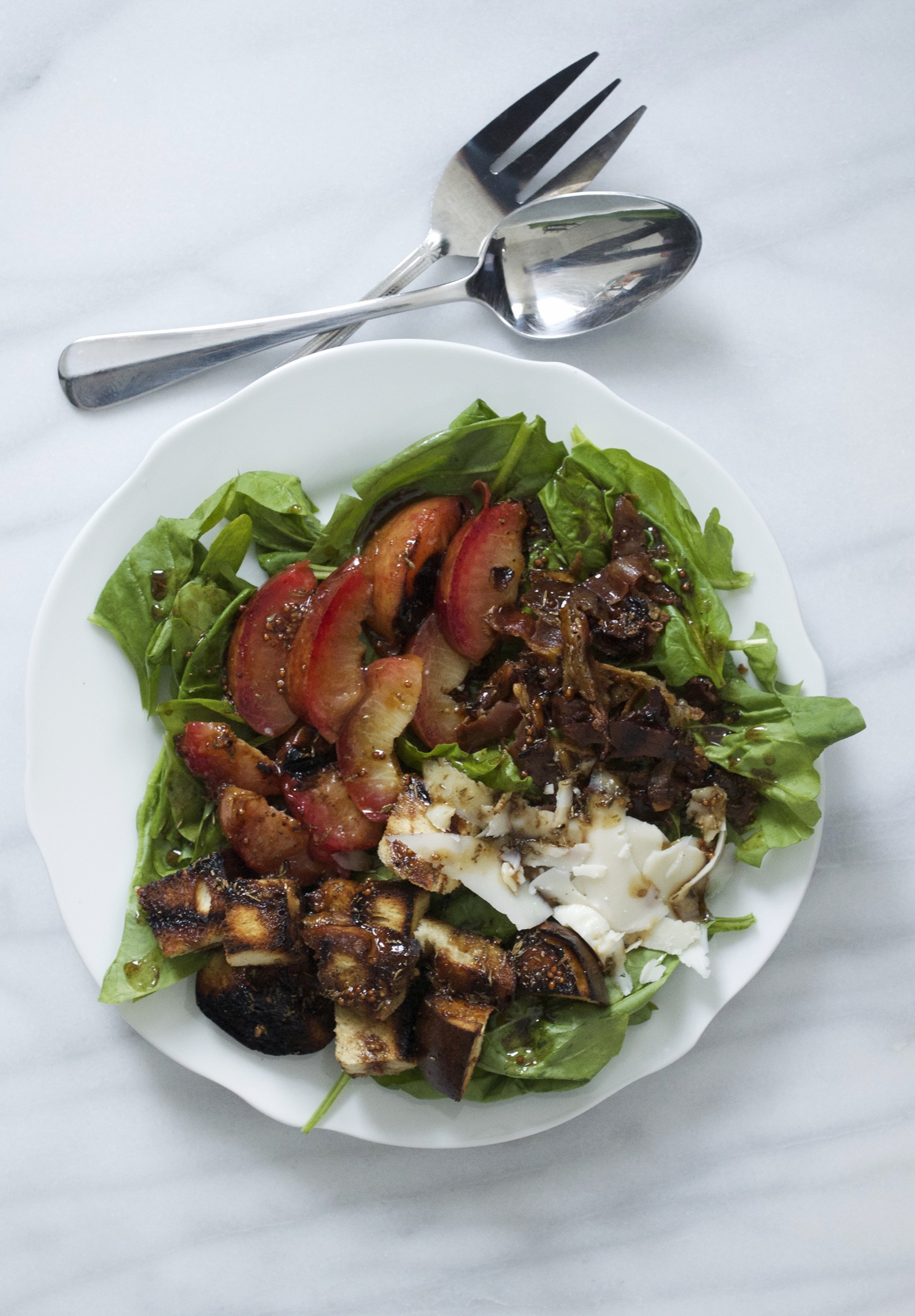 spinach salad with grilled plums, challah croutons, and honey-balsamic vinaigrette