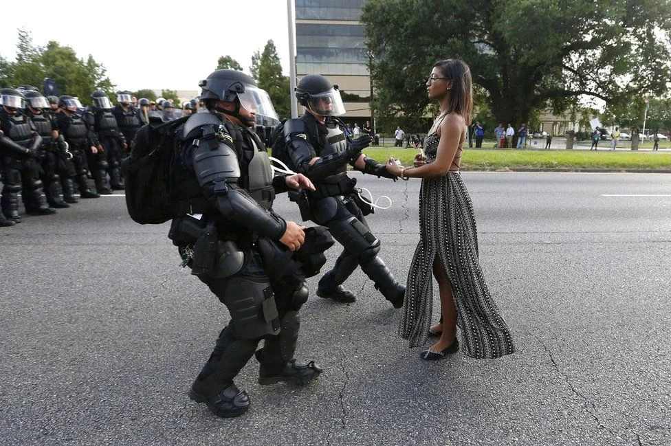 "Powerful" is how photographer Jonothan Bachman described protester Ieshia Evans. I find this image powerful on so many different levels. The more I look at the image the more I find, the more I examine, the more I question, which is exactly what the most powerful photography does. Evans is detained by law enforcement as she protests the shooting death of Alton Sterling near the headquarters of the Baton Rouge Police Department in Baton Rouge, La., on July 9, 2016.