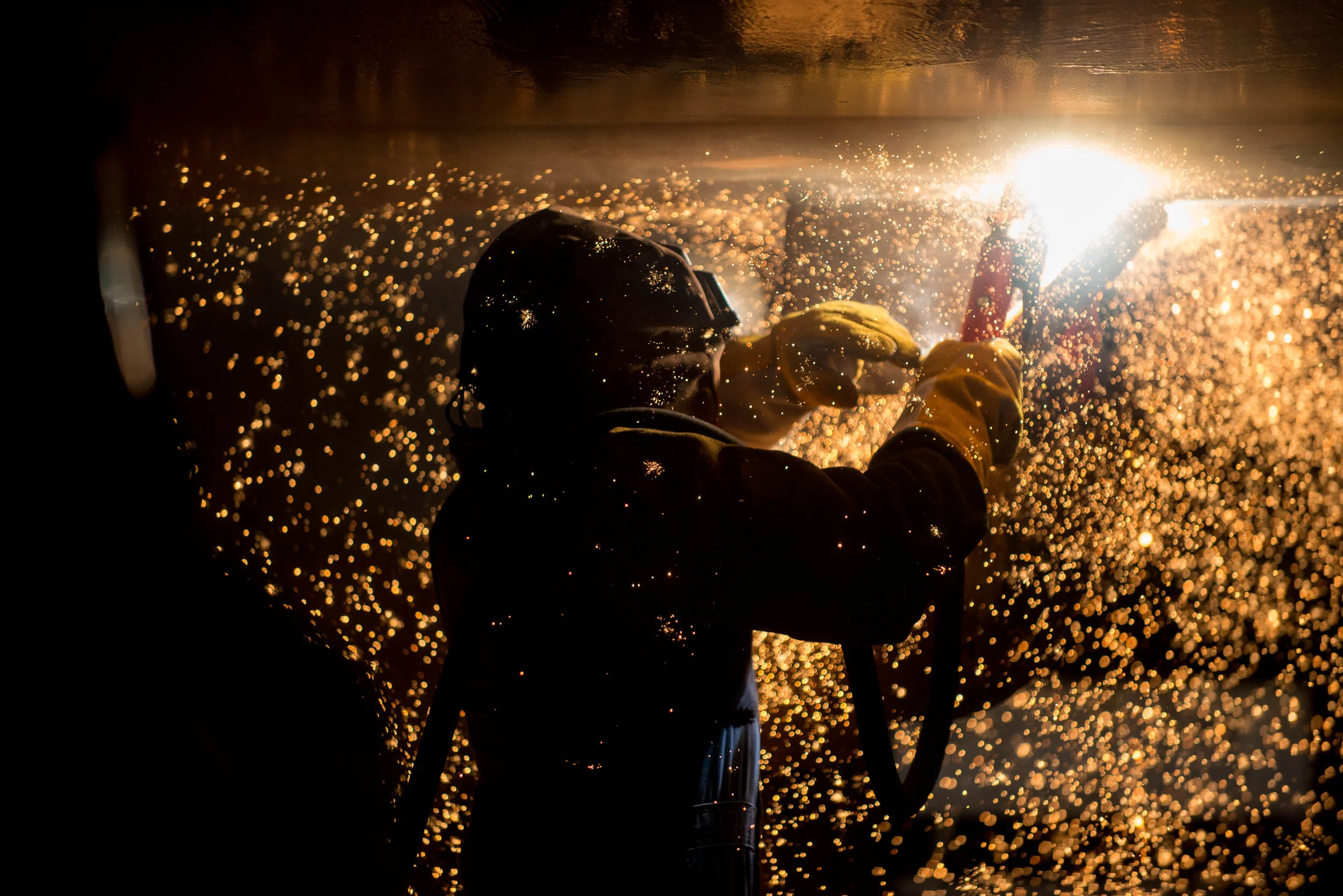 Welder working on ship