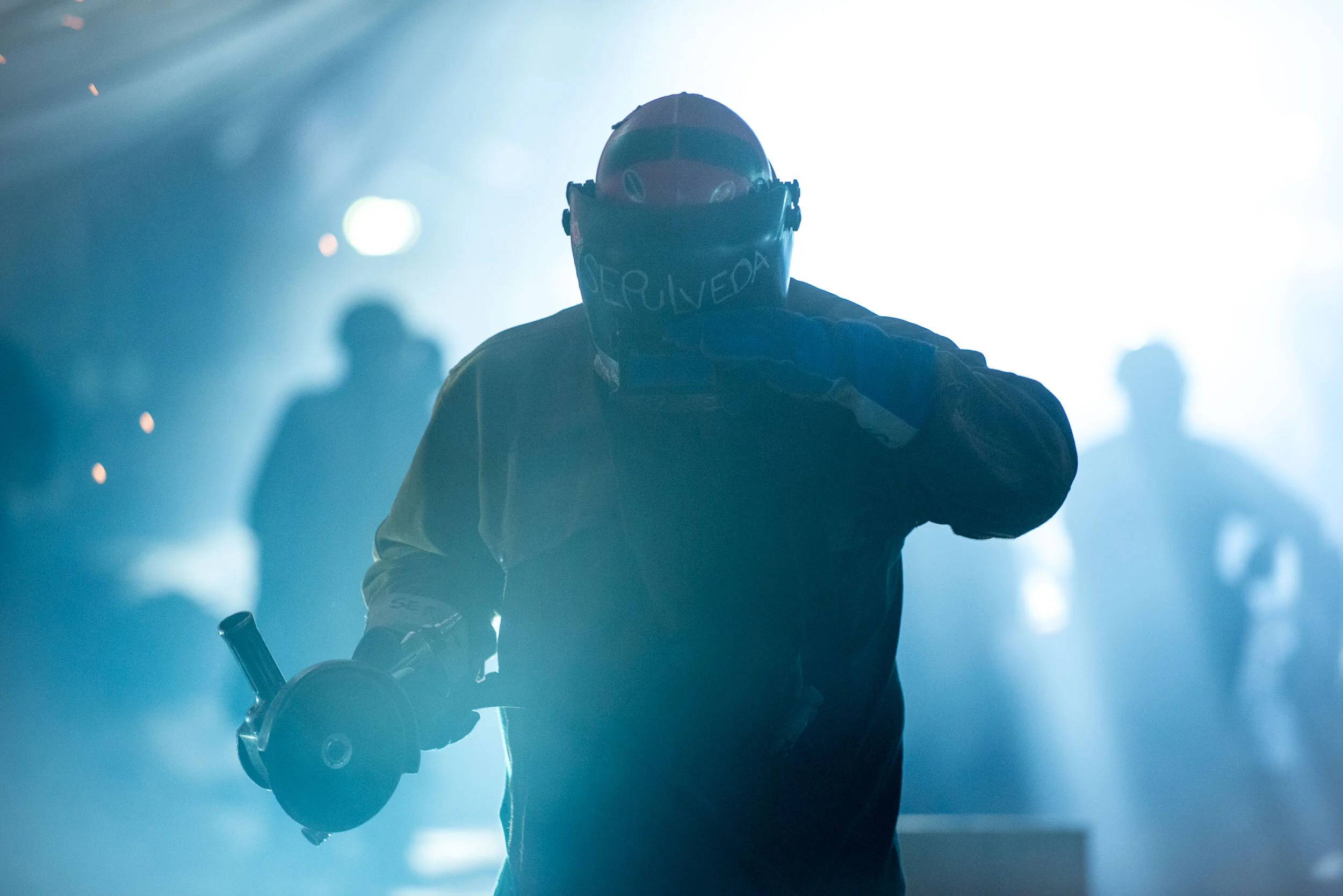 Grinder walks through haze in shipyard