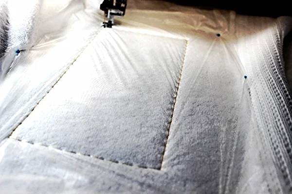 The basting keeps the topping in place and taunt while the design stitches.
