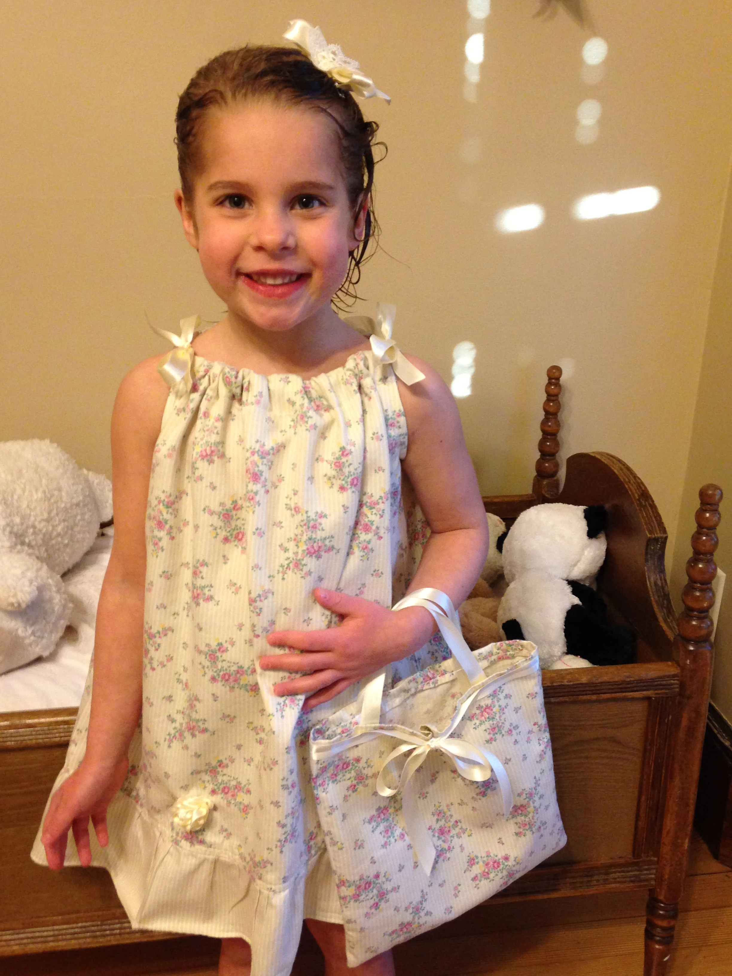 Pillowcase dress on the sweetest girl with a matching purse and rosettes made by her mom.
