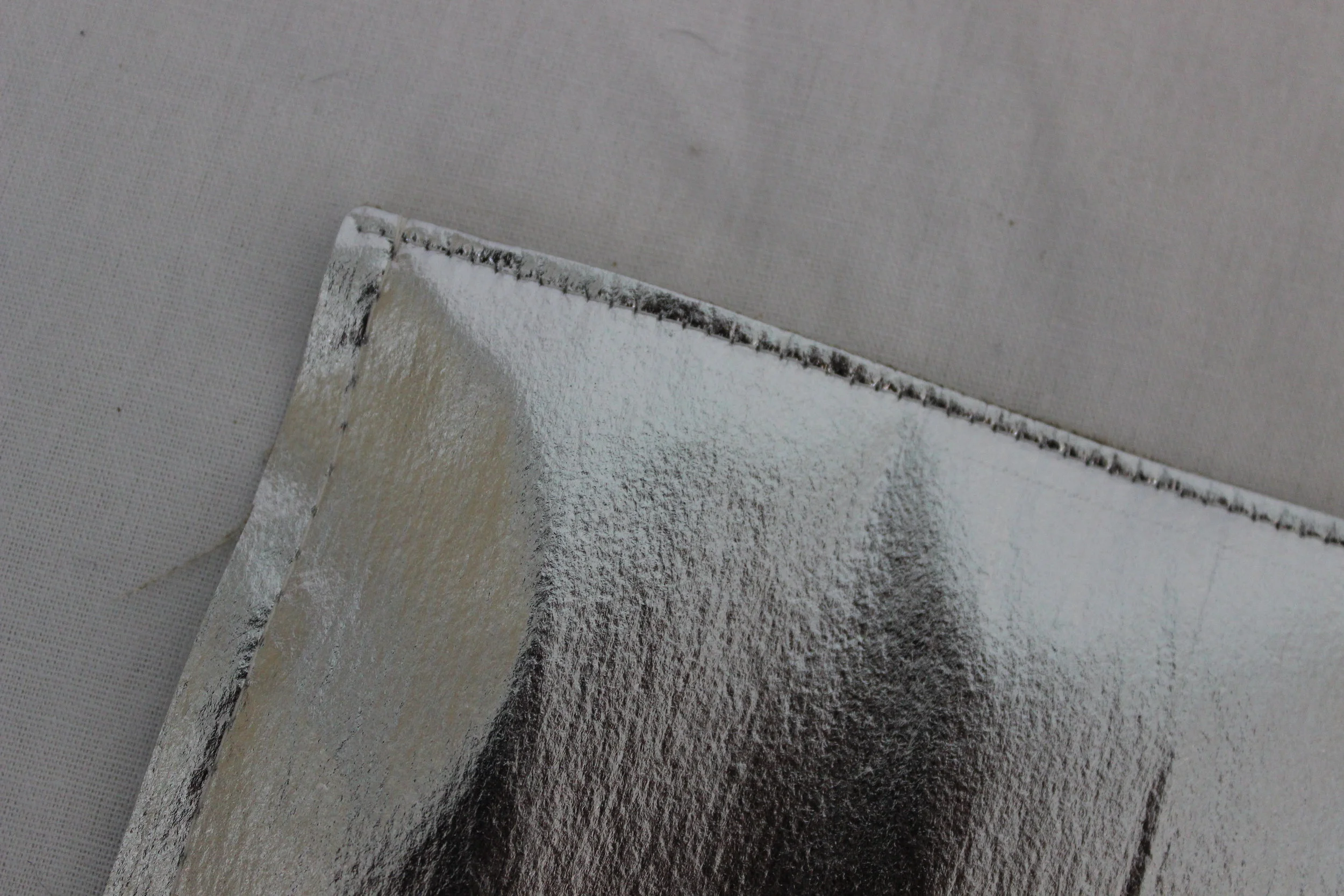 Solarize Liner fabric topstitched at the top and basted on the 3 sides with linen on the other side