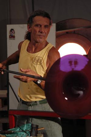 Spinning a "rondel" in front of the "Glory Hole", the reheating kiln in which the master works.