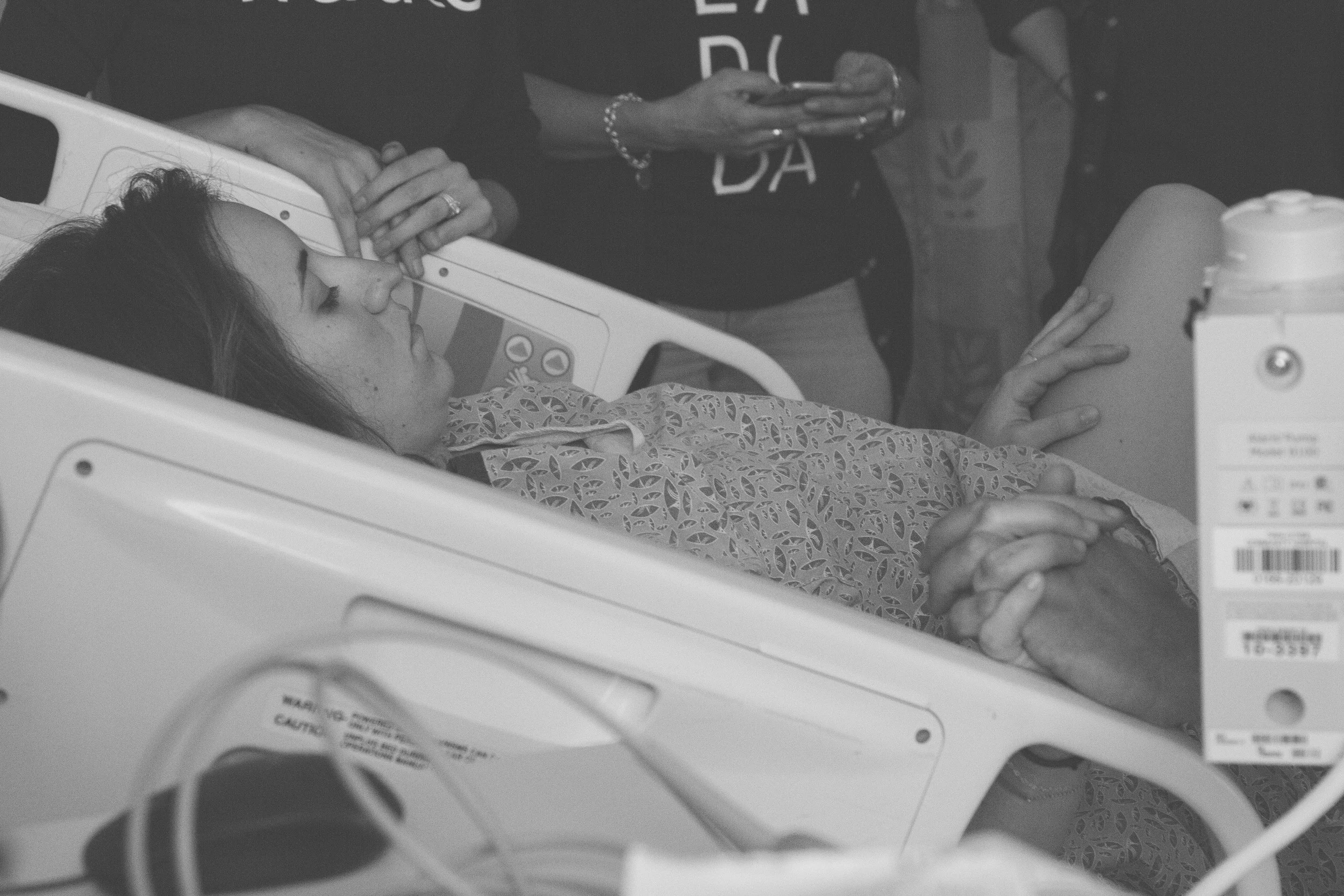 Since the epidural had completely worn off, it felt SO GOOD to push. It was a huge relief. Everyone started to talk about some black thing coming out when i was pushing. They didn’t know what it was. After several more pushes they realized it was hair. A chunk of the babies hair would slip out while pushing. They thought it was so funny. I couldn't see it. I did think, “Sweet. She has hair.” I kept pushing. The doctor arrived and was awesome. I could feel the baby crowning. Talk about BURNING. Holy moly. The further along we got, the worse it got. I could just feel her head stuck there waiting for the next contraction to push.