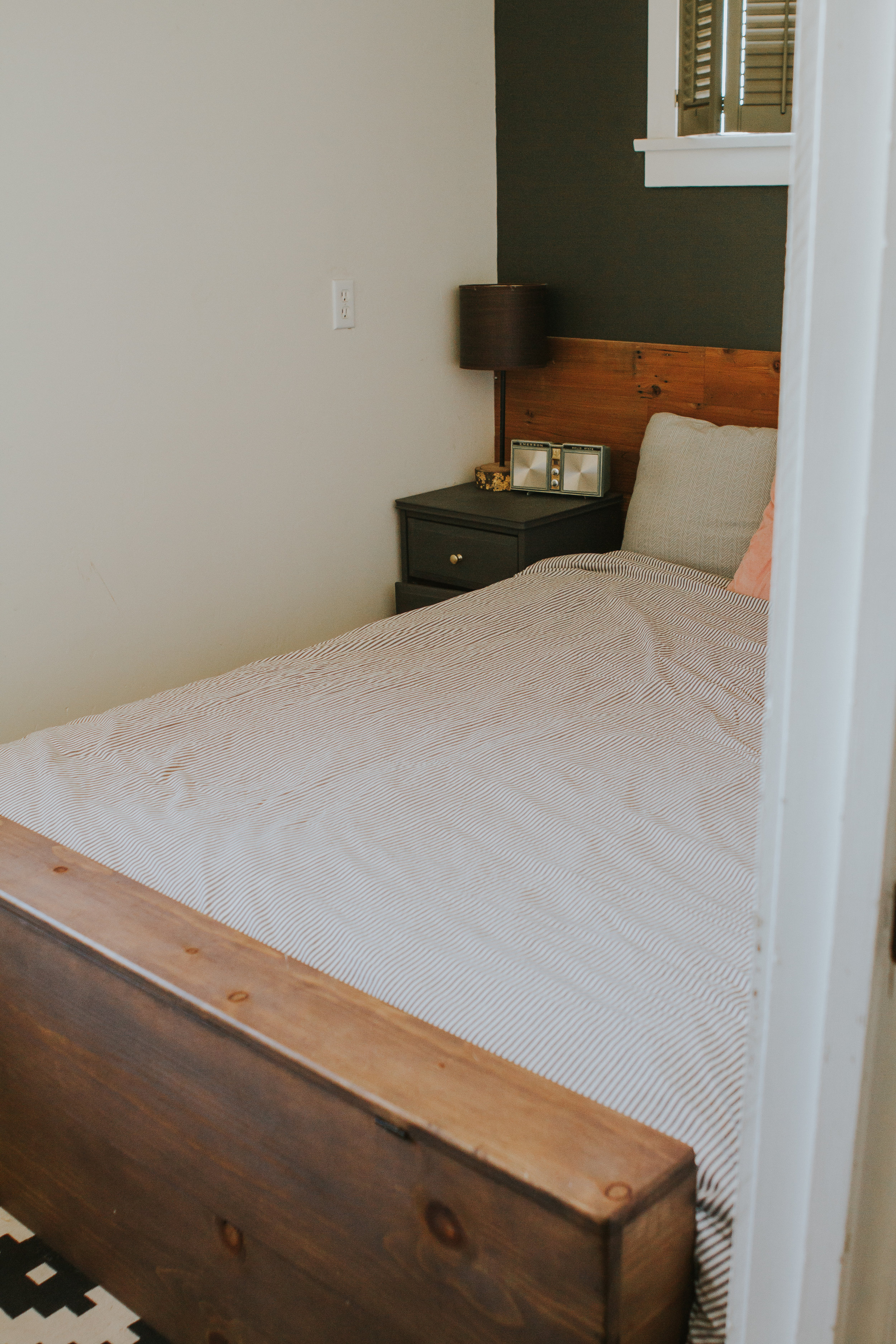 Chad made our footboard and the top flips open. Inside is a TV that can slide up and stand so we can watch tv in bed. (we are so lazy) and theres some room in there for our extra bed linens. 