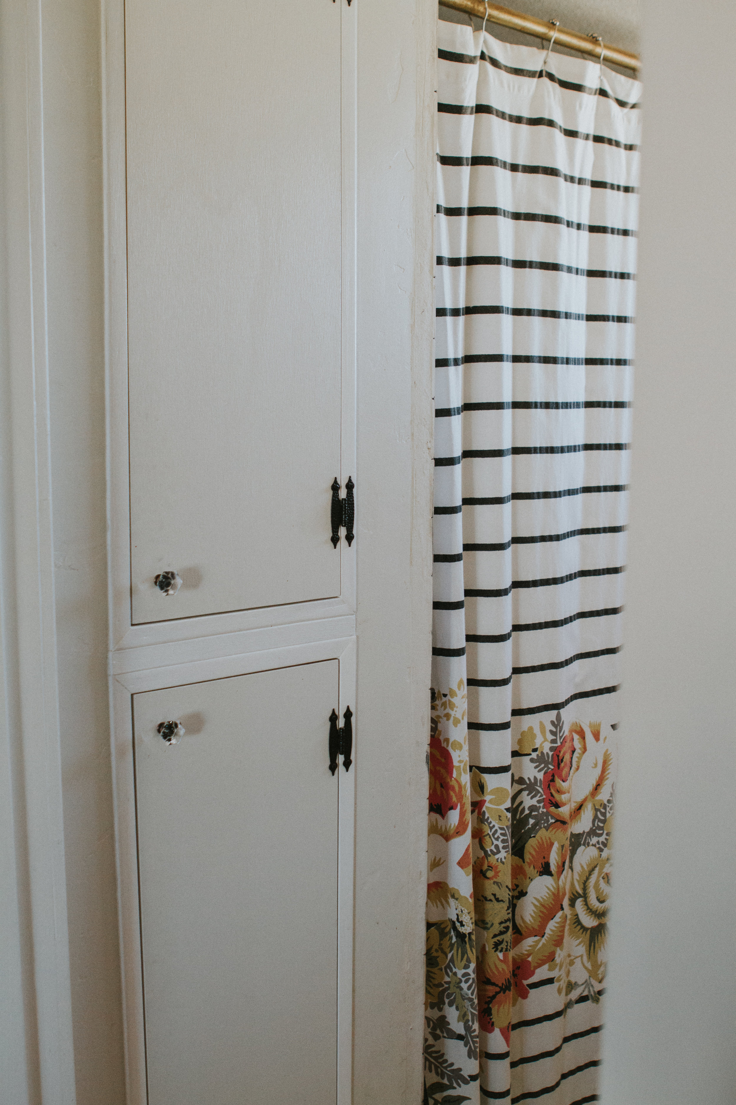 Our bathroom has little cabinet space to put anything so Chad knocked out this wall and added these two little cabinets to put towels and medicine.