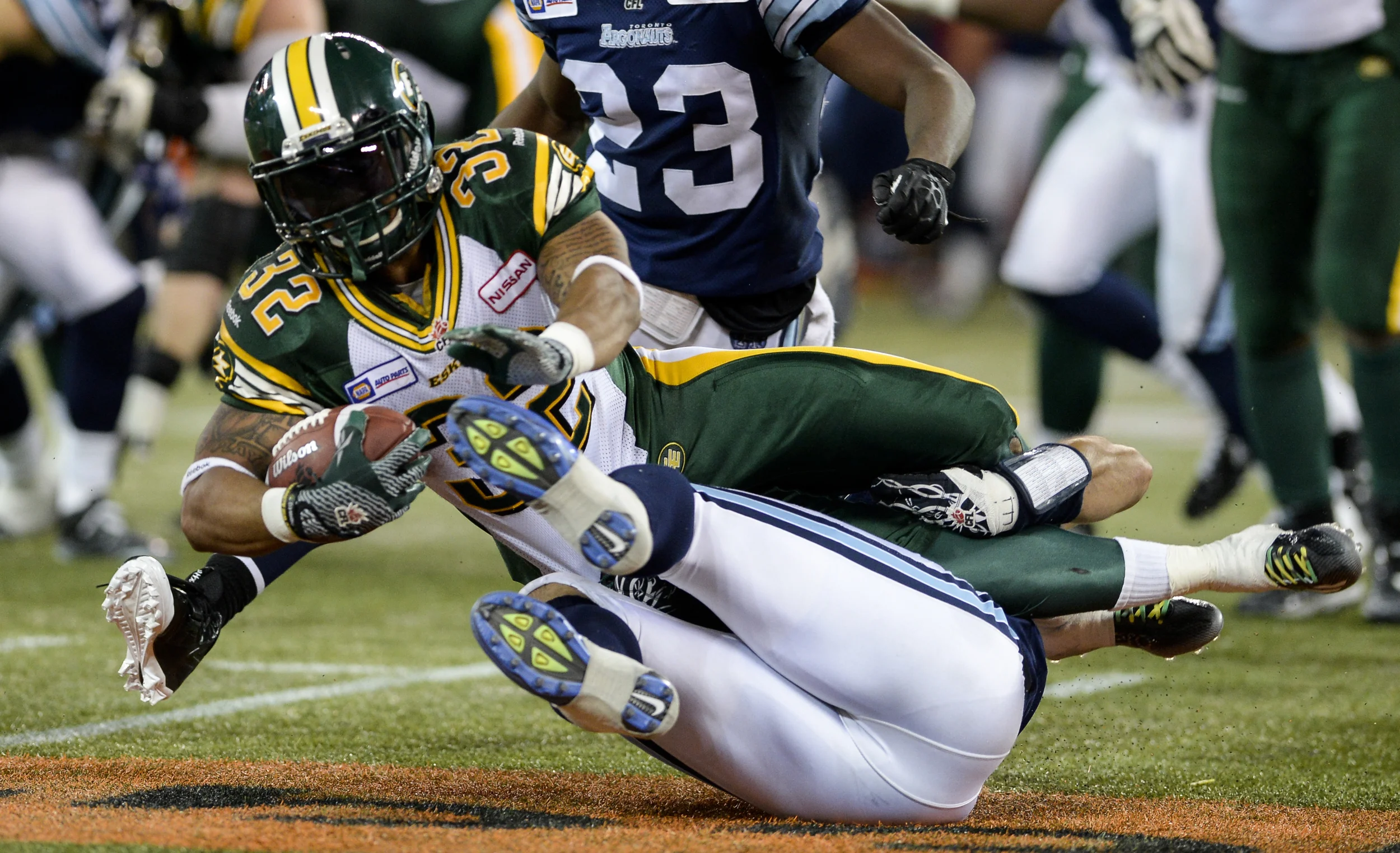  Edmonton Eskimos slotback Kendial Lawrence gets tackled by a Toronto Argonauts player during a game at Rogers Centre on October 4, 2014. The Argos came out on top with a 33-32 victory. 