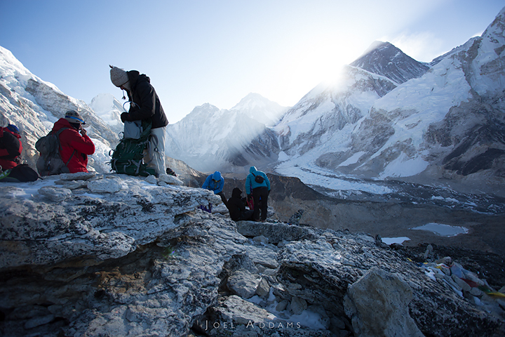 Sunrise on Kala Patthar (Everest in the far background). After having visited Everest Base Camp the afternoon before, the group makes an early sunrise hike up to the high point of the trip: Kala Patthar at 18,514 ft (5644 meters). Photo by Joel Addams