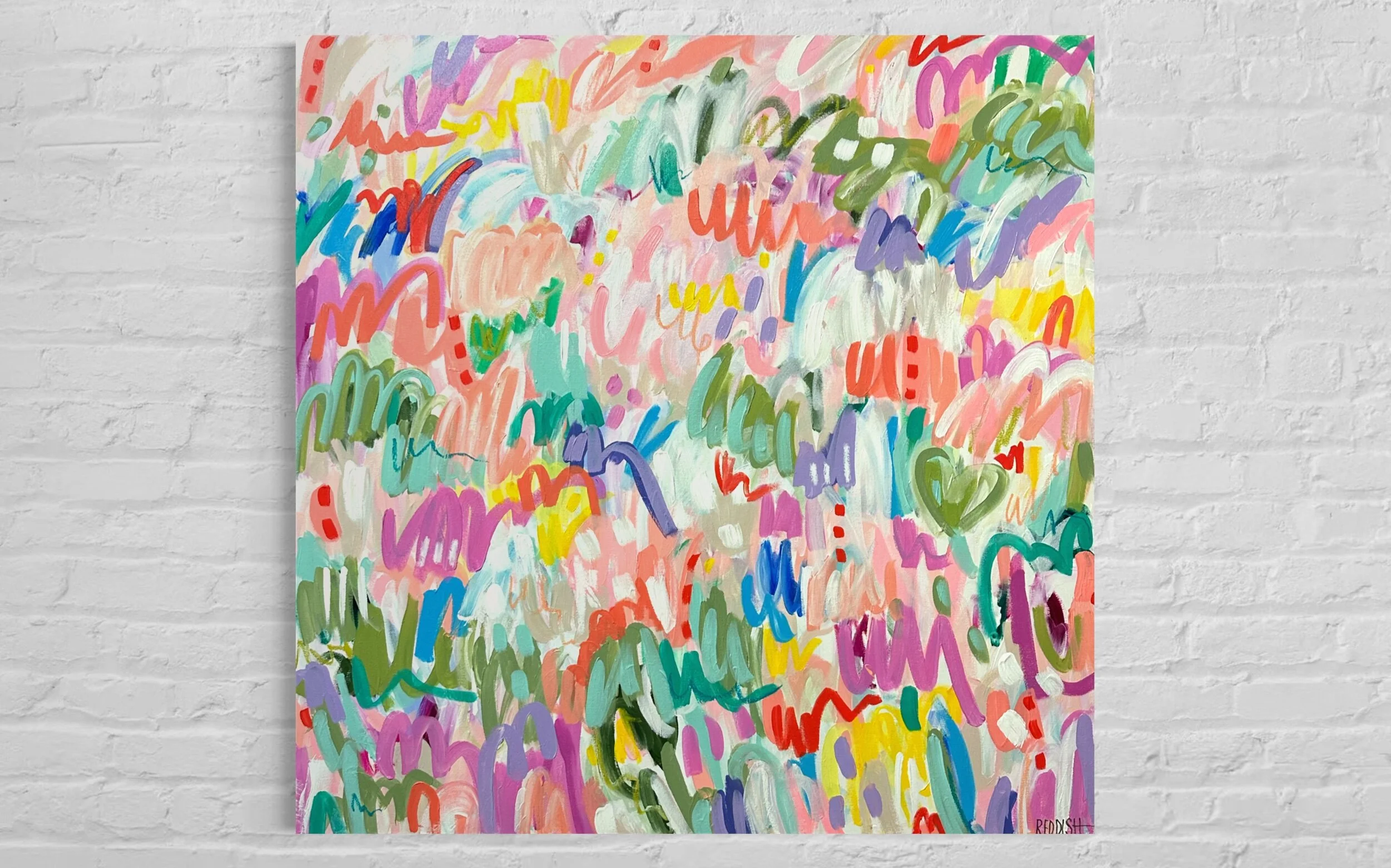 Colorful abstract painting with various brush strokes and scribbles in pastel colors on a white brick wall background.