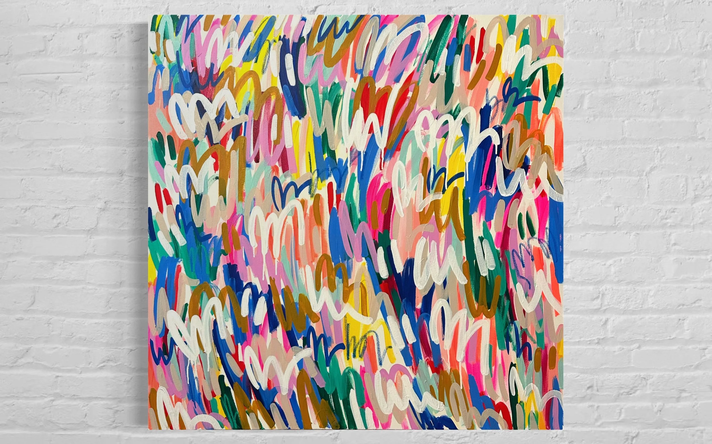 Colorful abstract painting featuring a multitude of overlapping heart shapes in bright and pastel colors, displayed on a white brick wall.