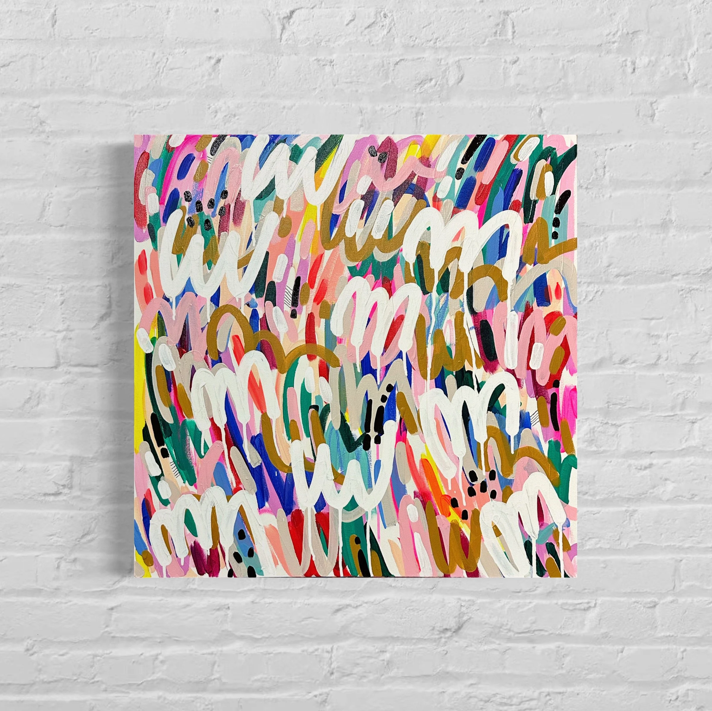 Close-up of a colorful, abstract painting with various brushstrokes and colors, mounted on a white brick wall.