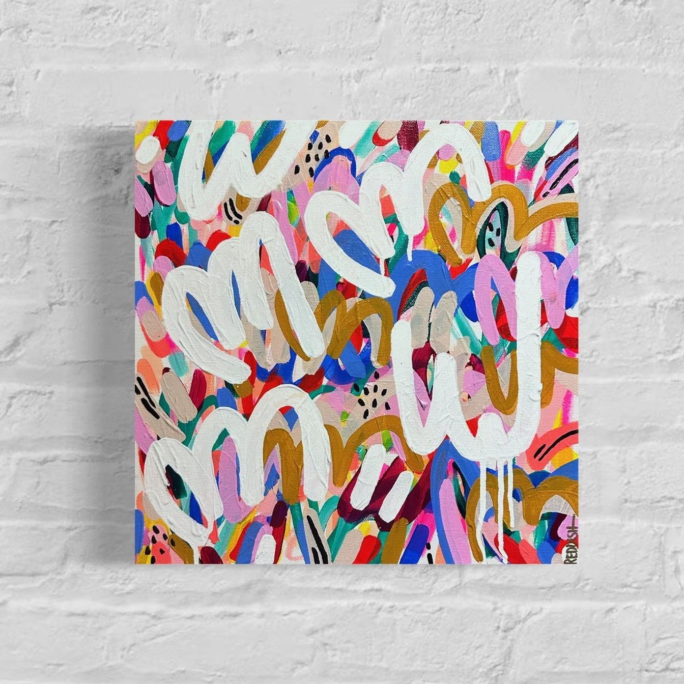 Colorful abstract painting with various brushstrokes, shapes, and the words 'You are loved' written in large white script across the center.