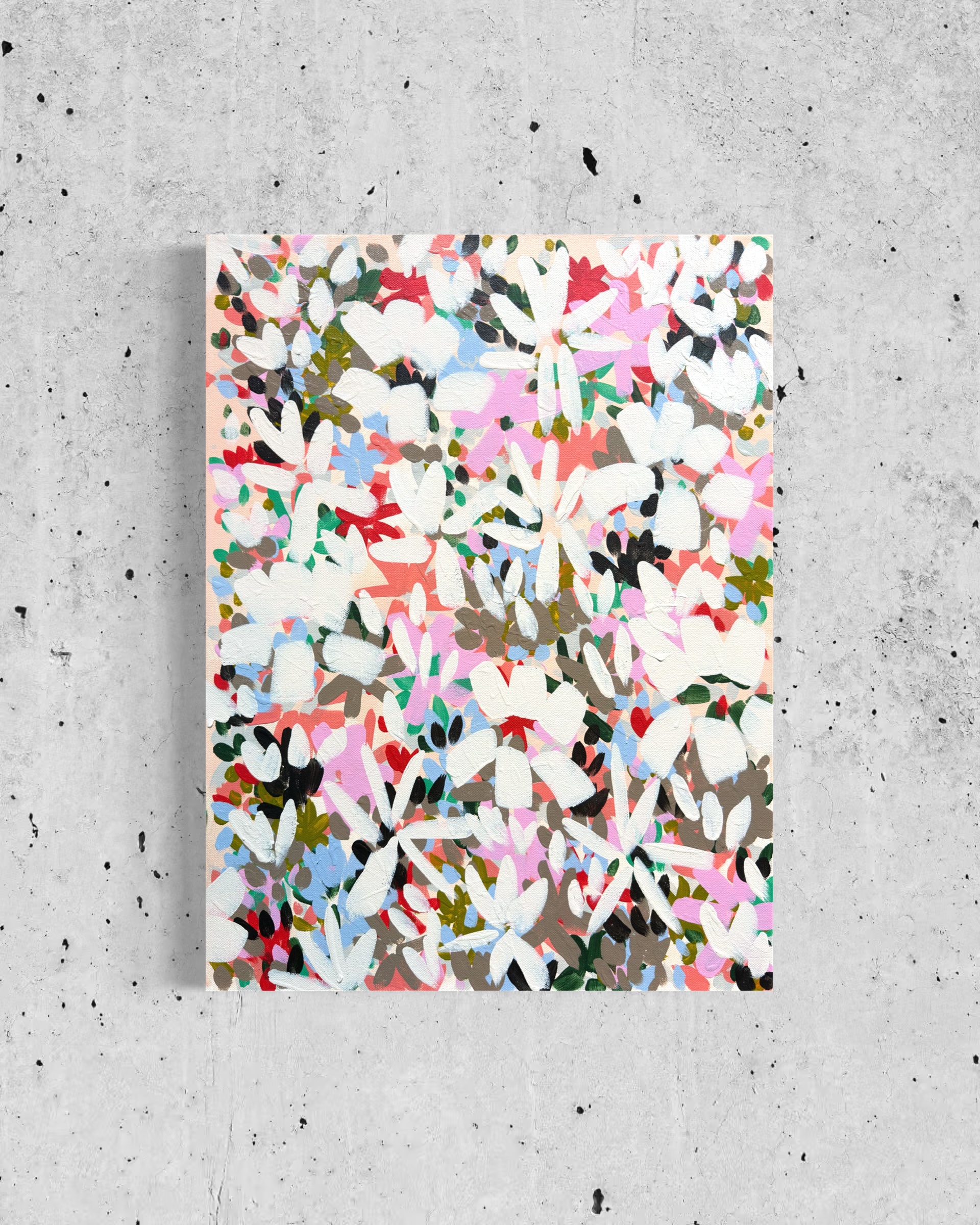 Abstract floral artwork on a rectangular canvas, placed on a concrete surface.