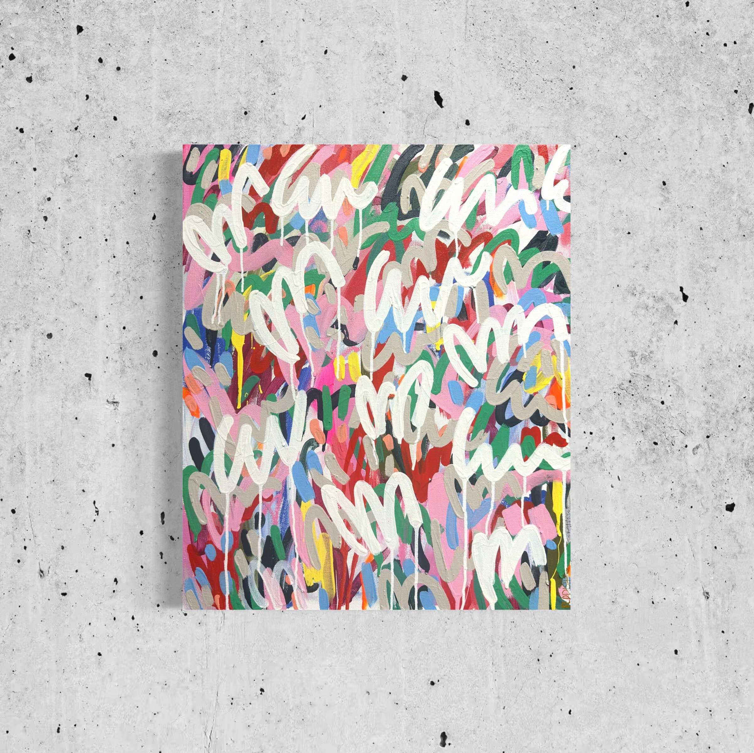 Abstract painting with colorful, overlapping brushstrokes on folded paper, set against a plain, speckled concrete wall.