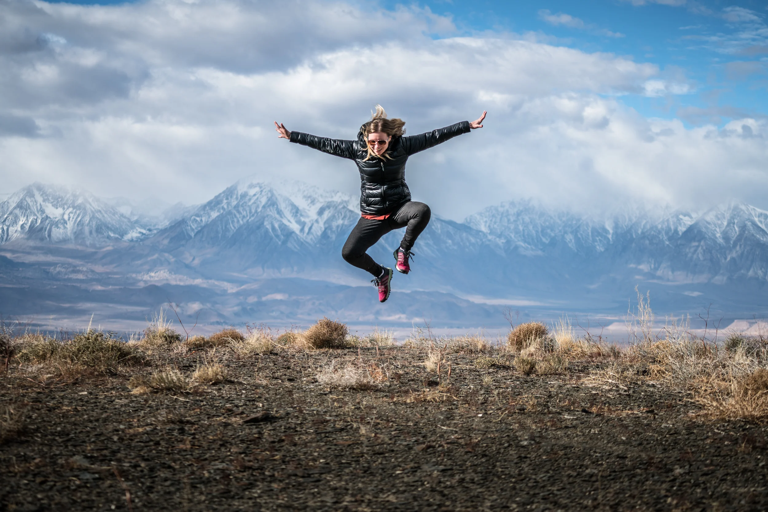 girl-jumping-mountains-sunset.jpg