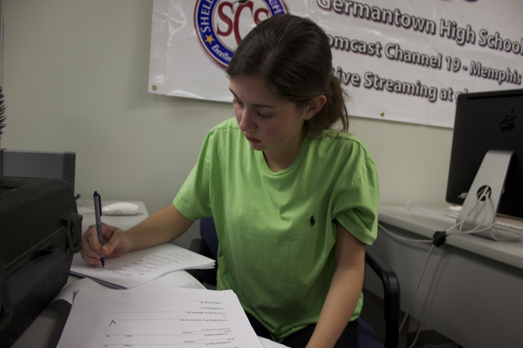  US House anchor Haylay Bardos finishes up her report script. Bardos spoke with area teens about the importance of compromise in light of the perception that the US congress can't seem to do so. 