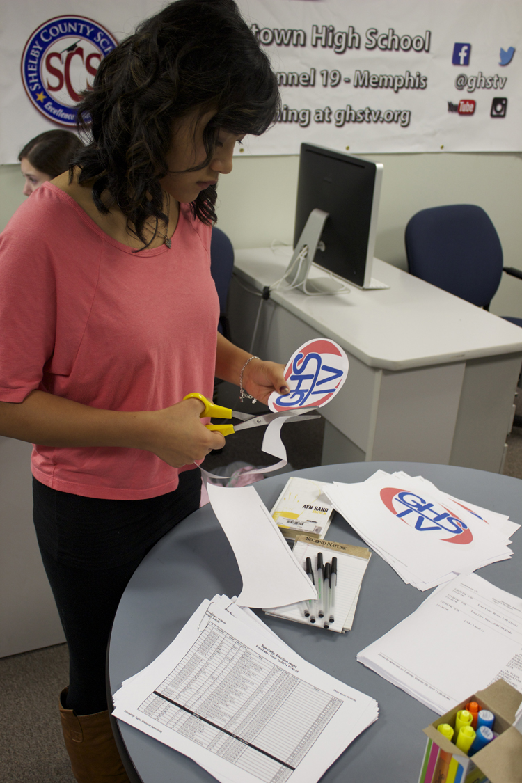 Details matter, especially to overall producer Taylor Shennett. She's cutting out GHS-TV logos to use on set for the live show.