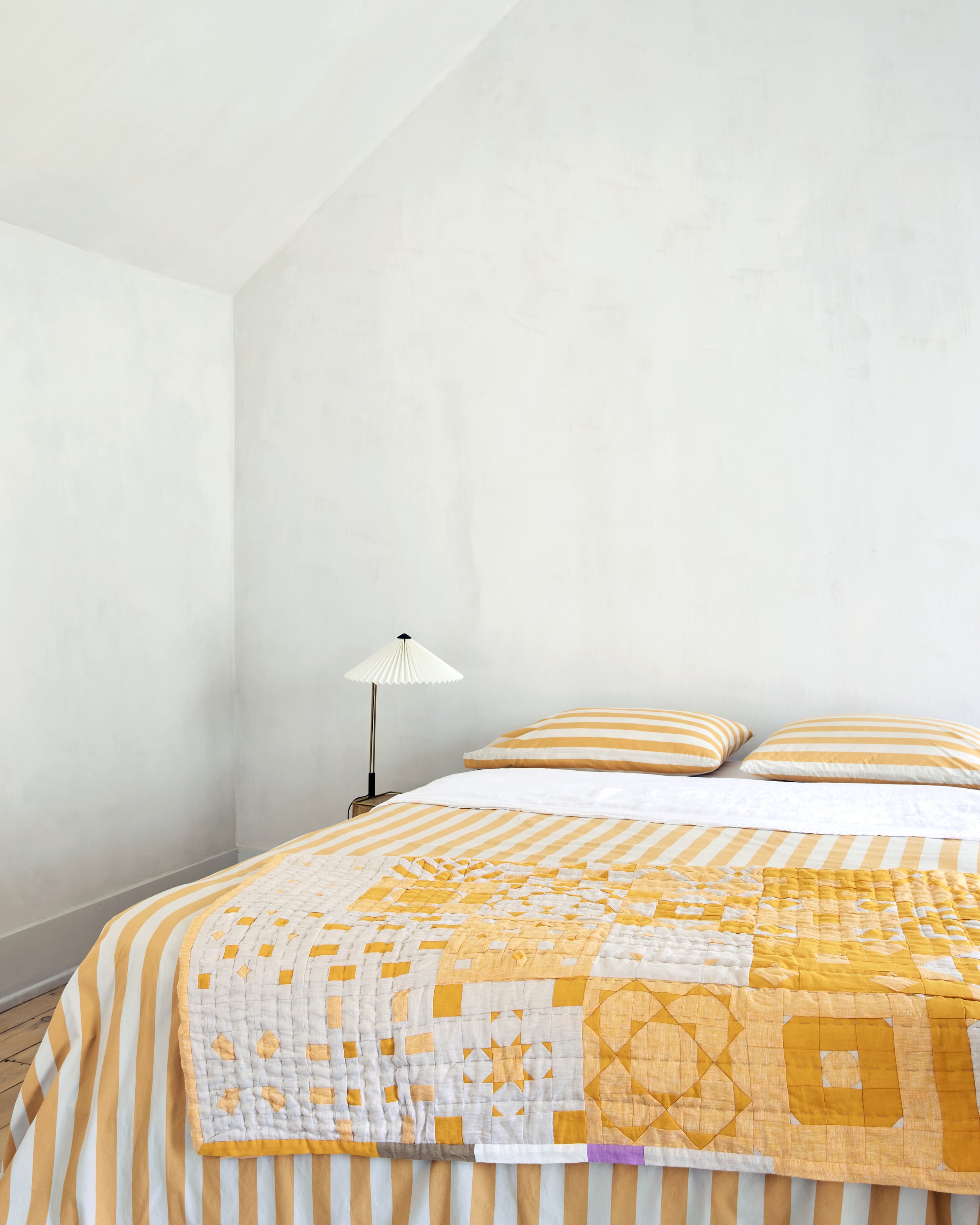 yellow old quilt stripe bed.jpg