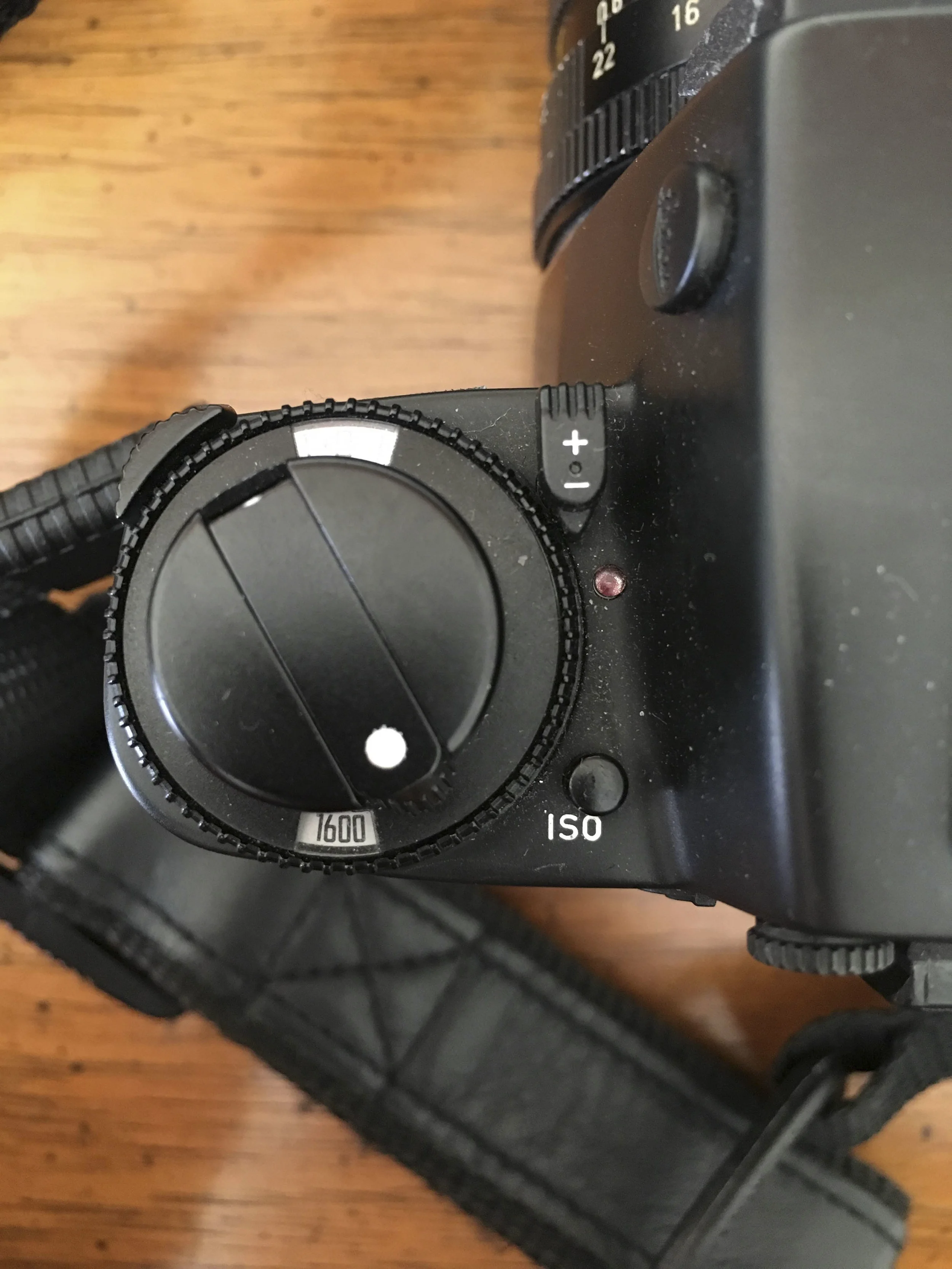 to adjust the iso you have to hold down the iso button and twist the dial to desired iso. To operate the exposure compensation dial you move the +/- to down and to side and then move the switch on the top left of the dial to move the wheel.