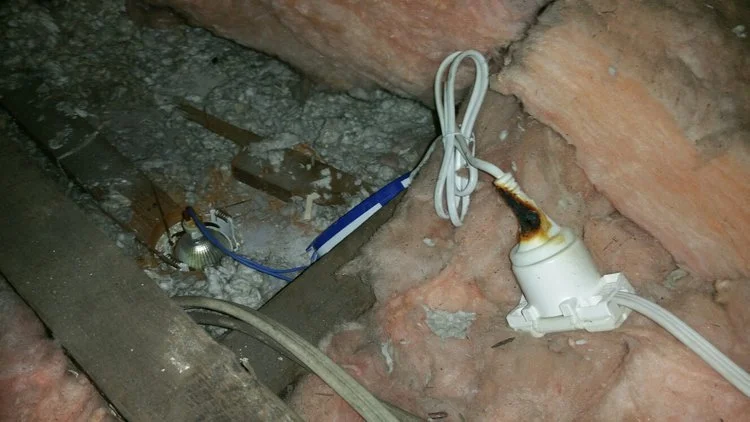 This electrical plug was resting on a downlight globe and was burnt severely. We moved it off the light and informed the owner.