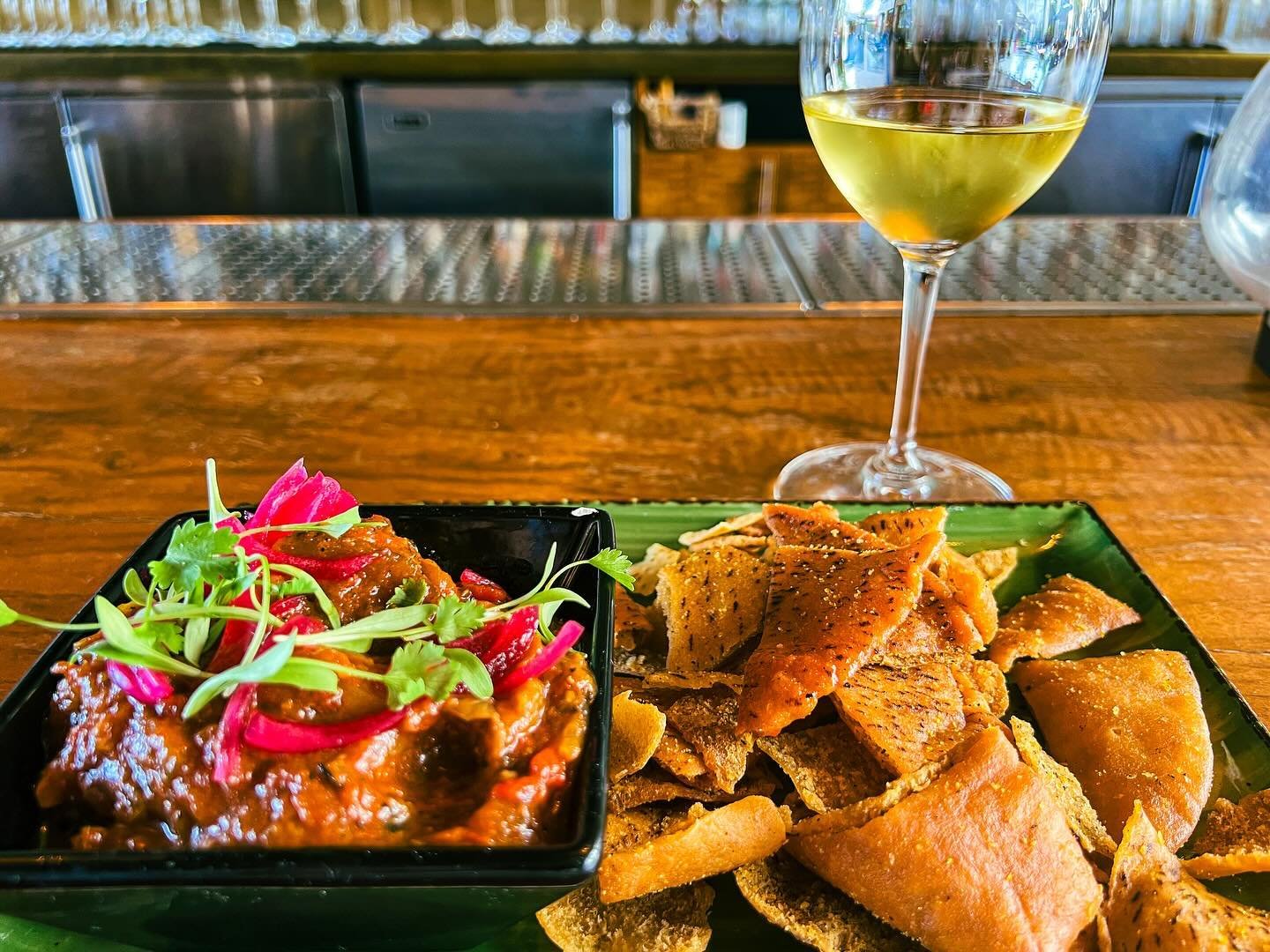 My Welcome to LA - a brightly flavored plate of roast eggplant dip with sumac-spiked pita chips (but it&rsquo;s the micro cilantro on top that adds the sparkle to this captivating dish). With a glass of Mosel Riesling and the promise of more to come 