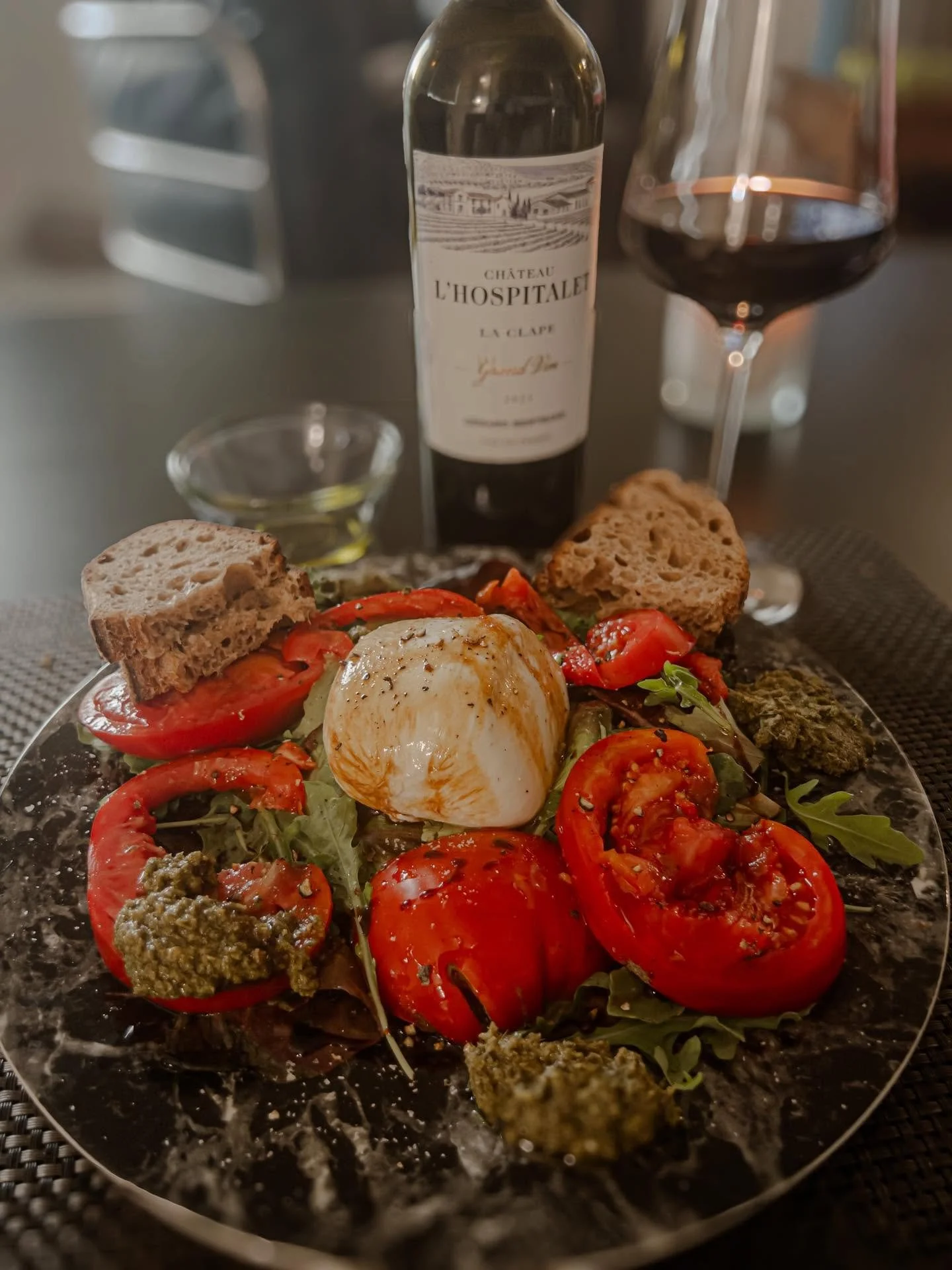 Great wine and a simple dinner - farm stand tomatoes, leafy greens, fresh burrata, pesto and olive oil from Provence plus the extraordinary Ch&acirc;teau l&rsquo;Hospitalet from the heart of Languedoc. The meal shone just as brightly as the candle in