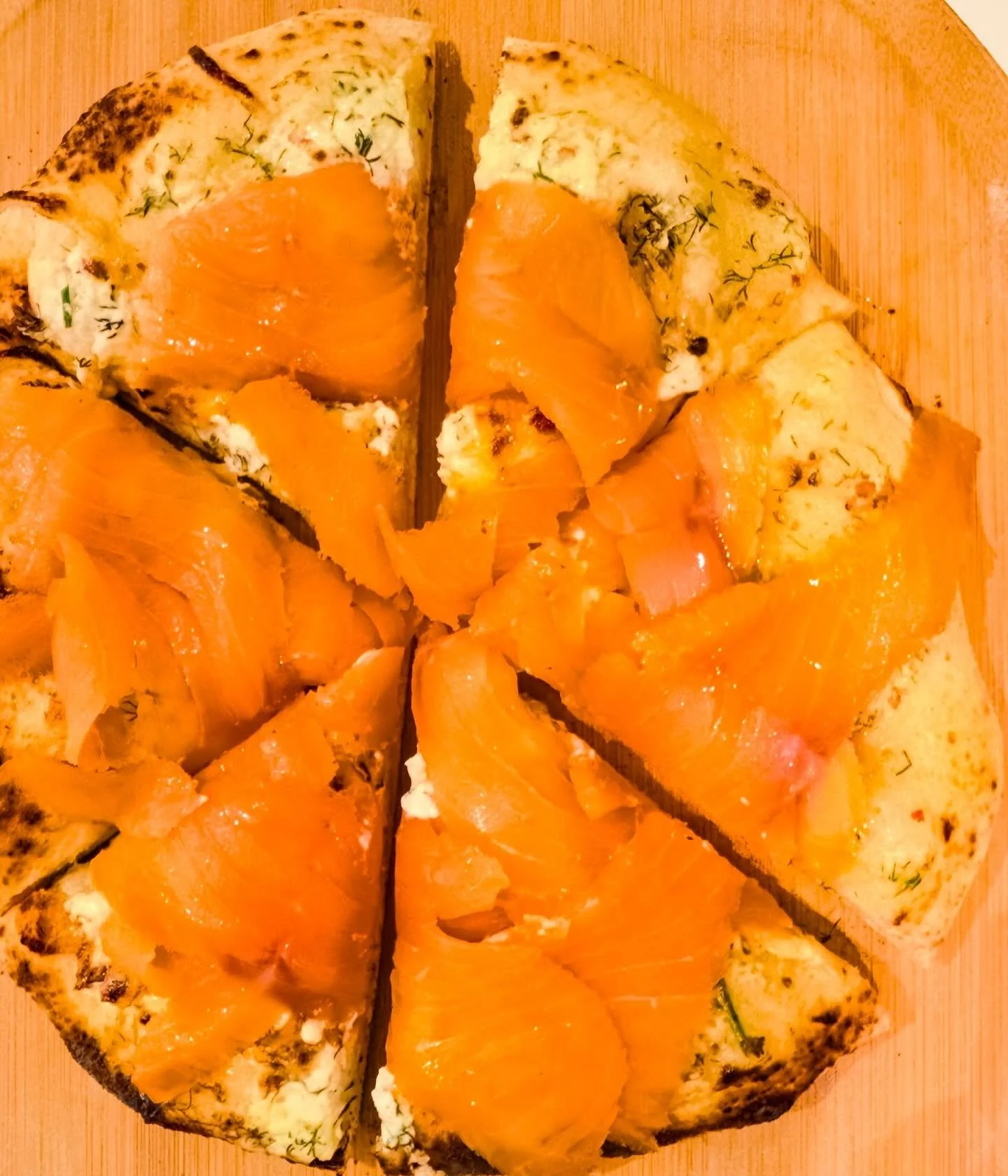 Last night&rsquo;s pizza - Neapolitan crust with cr&egrave;me fra&icirc;che, pink peppercorns and dill, a bit of mozzarella, a quick bake in the @oonihq pizza oven then topped with smoked salmon. Made two in less than 5 minutes, a light appetizer at 