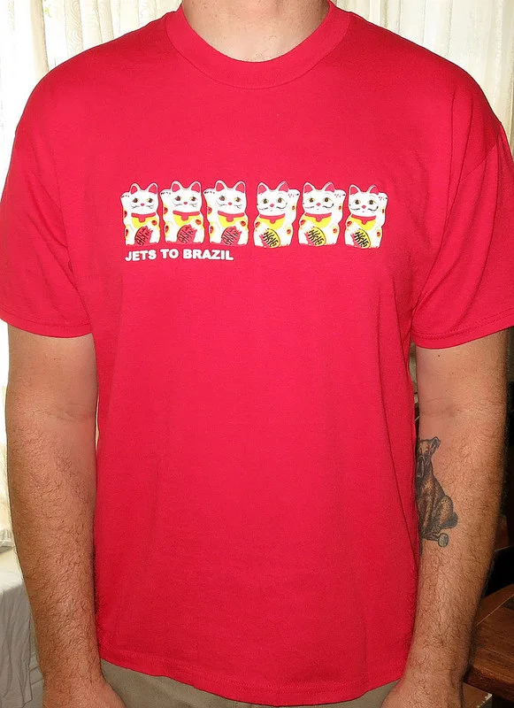 theminorthread : Day : 1094
Shirt : Jets To Brazil - Fortune Cats
Color : Red
Brand : Hanes Heavweight 50/50
Source : I really find the whole Jets To Brazil thing really interesting. its kind of a band project that came out of the blue and didn’t have much like it out in the music scape at the time. while at the time it seemed to be hit or miss for a lot of people, but i think the albums aged really well. listening them today, 15 years later they almost seem more relevant sounding now than they did back then. i know people would give their left nut for a Jawbreaker reunion but i would be a guy who would fly someplace to see these guy play again for real. not like a one off show, but a real “lets do this band again” situation.