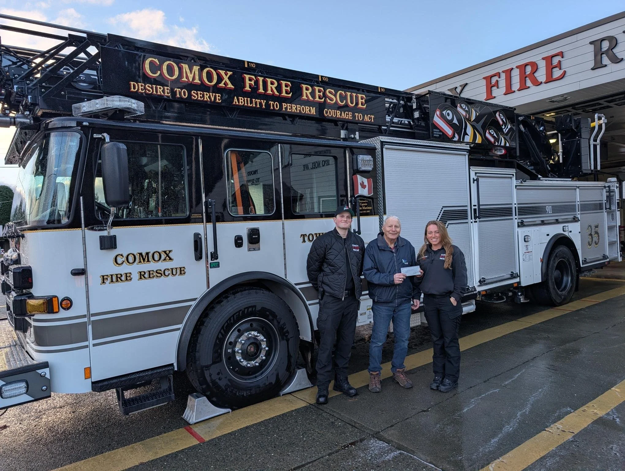 (Pictured Left to Right) Work Experience Firefighter Conor Hills, George Luterbach, President of Santa's Workshop, Lieutenant Elsa Gilroy