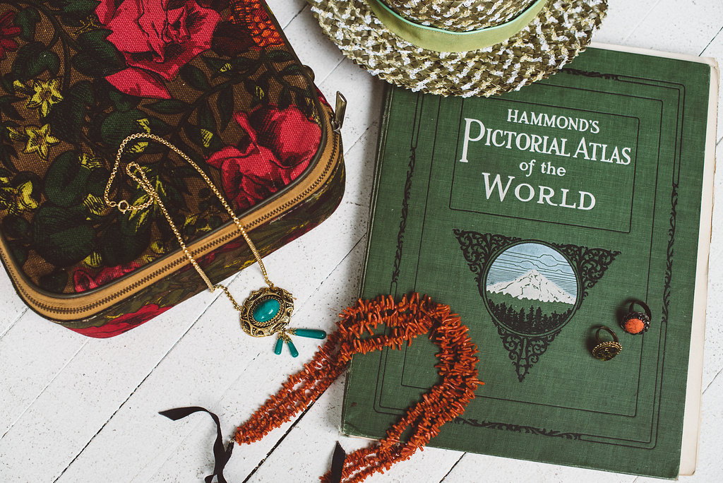 Atlas & Suitcase by Great Lake Outfitters, Jewelry & Hat by The Gallery