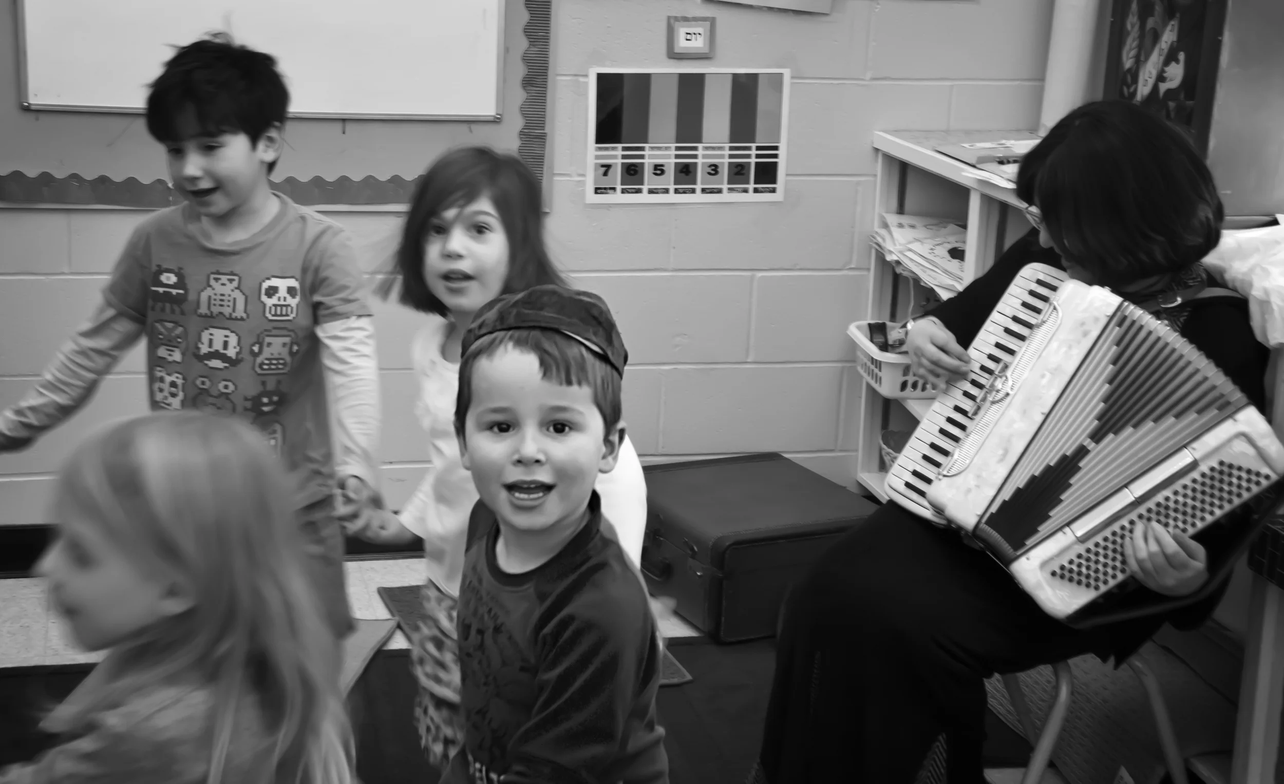 A teacher for thirty years, Debby Miller (right) plays the accordion for her preschool class at the Jewish day school, Akiva Academy. The song is played in honour for the upcoming Passover holiday, which celebrates the Jewish exodus from Egypt. Signing, “Hi ho, hi ho, goodbye to Pharaoh,” the class dances in a circle. Binyamin Habot looks up as Sarah Basya Andrews and Benjamin Ling follow behind. Attendance at Akiva Academy has almost doubled in the past three years, moving from 34 children in 2009 to 60 this year.