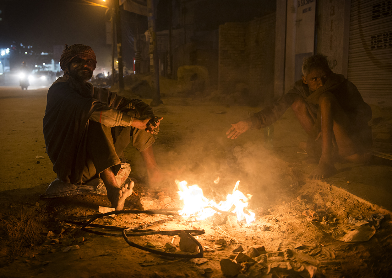 Once the sun sets in Varanasi, groups of men gather around fires in the street to warm themselves.