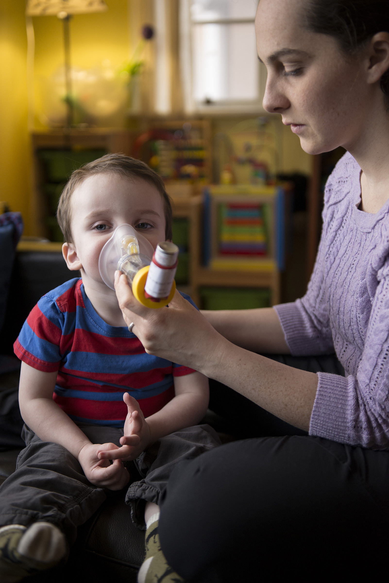 Rachael O'Neill helps Enzo, her two-year-old son, breathe after his medical equipment was stolen from their car just before Christmas, 2014.